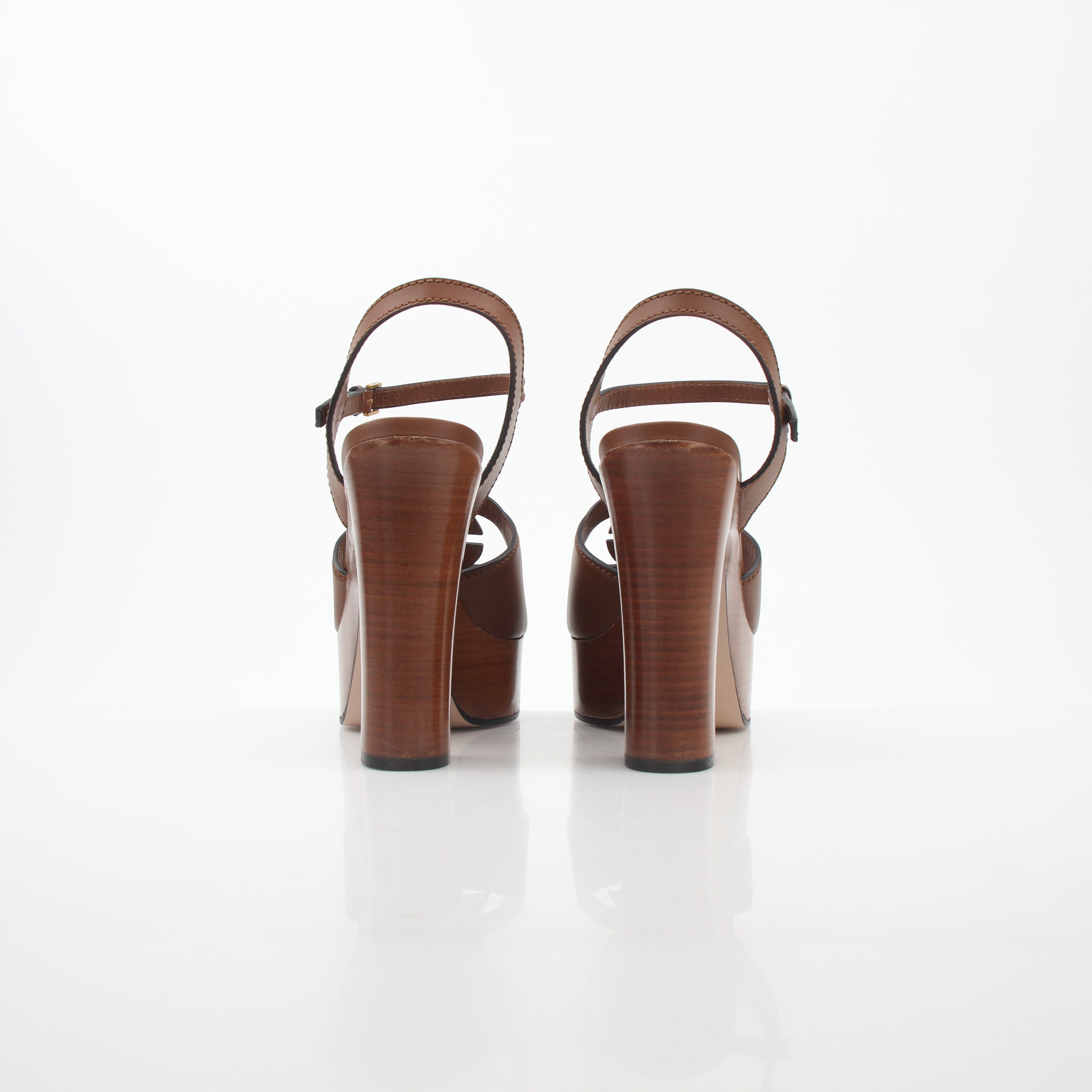 Gold & Beyond Gucci brown interlocking G cut-out platform heels with open toe and ankle strap, stylish and bold footwear.