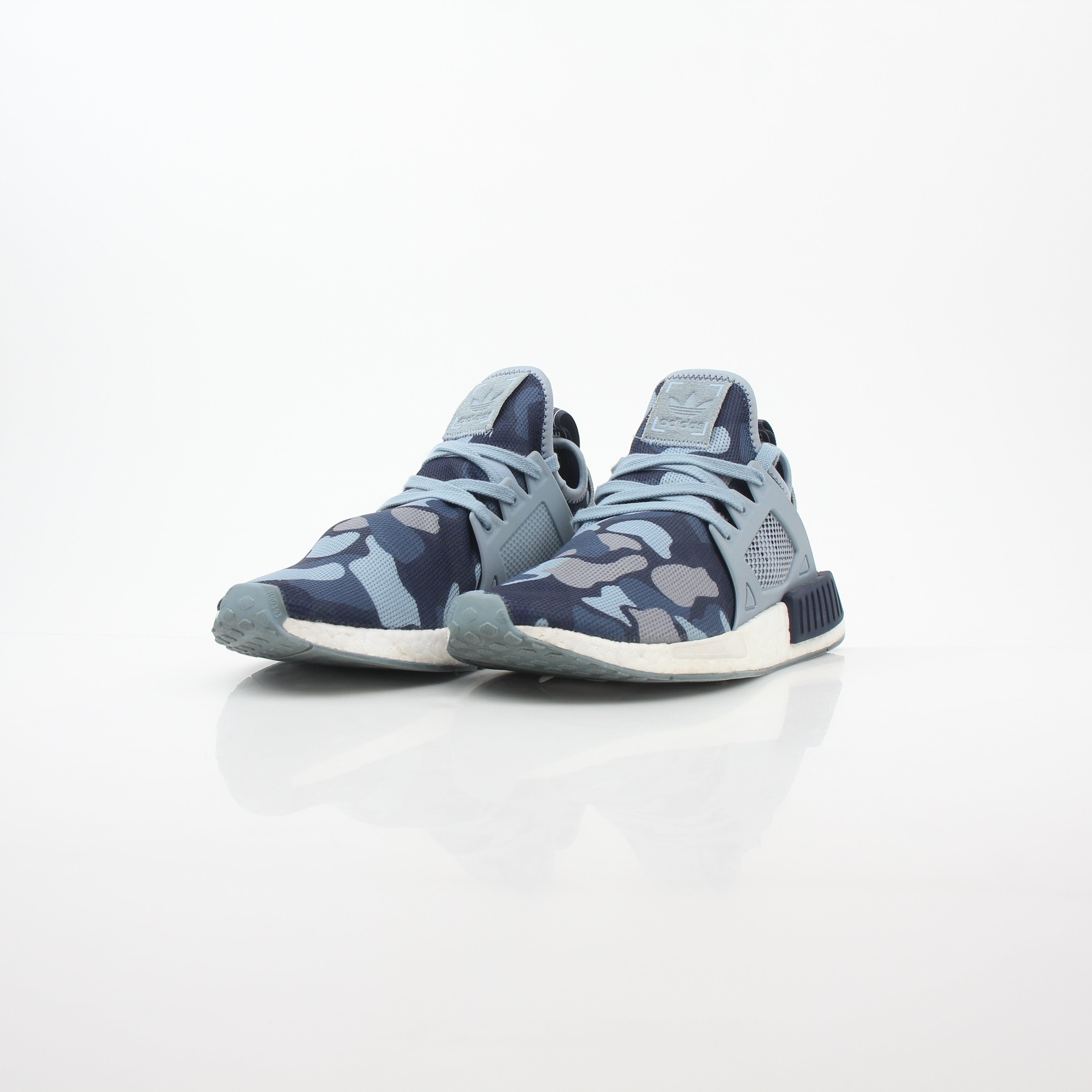 Adidas NMD XR1 PK Blue Duck Camo sneakers by Gold & Beyond with blue camouflage pattern and sporty shoe design.