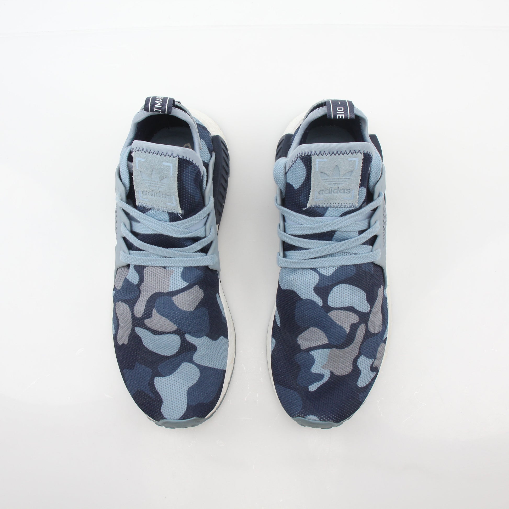Adidas NMD XR1 PK Blue Duck Camo sneakers with textured blue and black camouflage pattern, showcasing their stylish design.