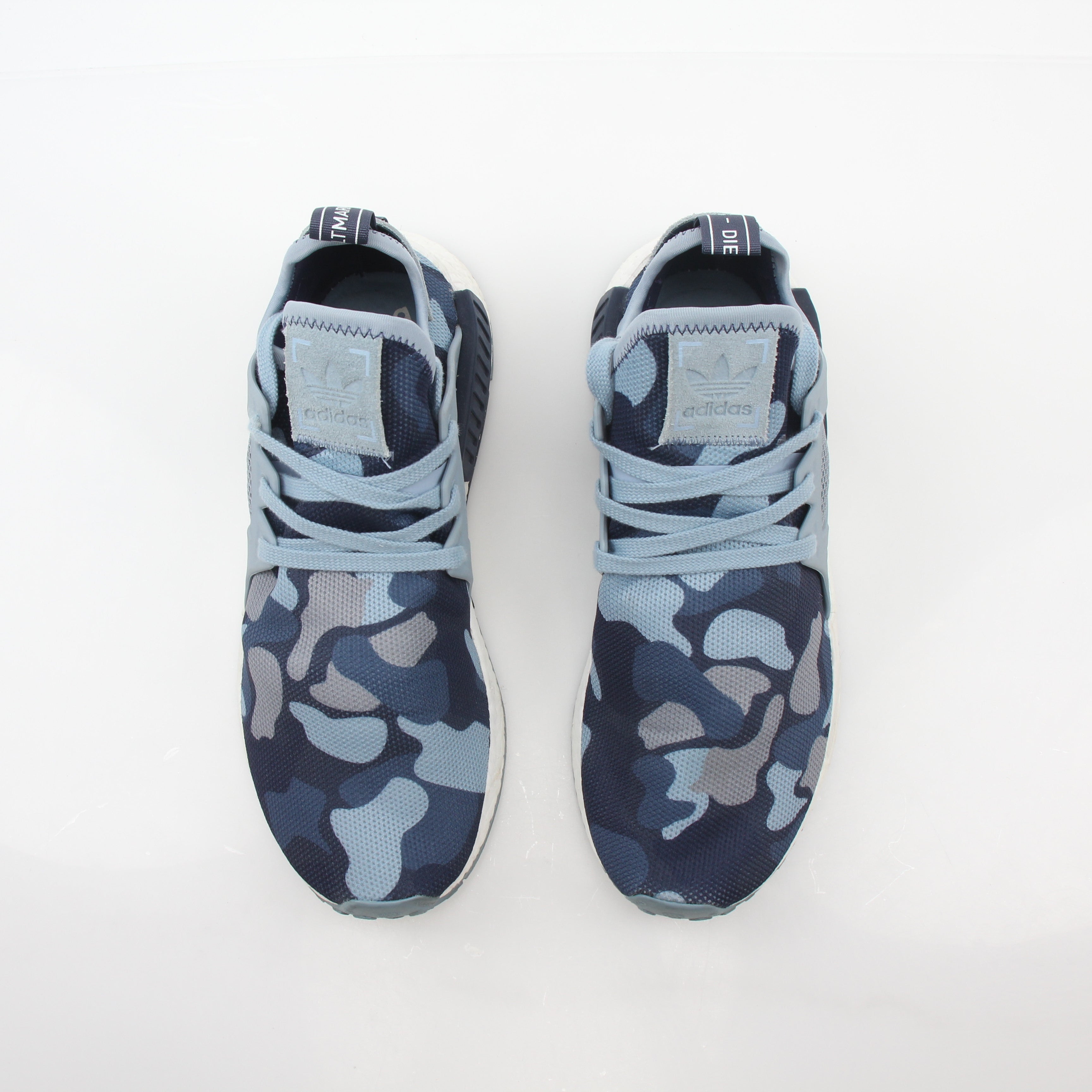 Adidas NMD XR1 PK Blue Duck Camo sneakers with textured blue and black camouflage pattern, showcasing their stylish design.