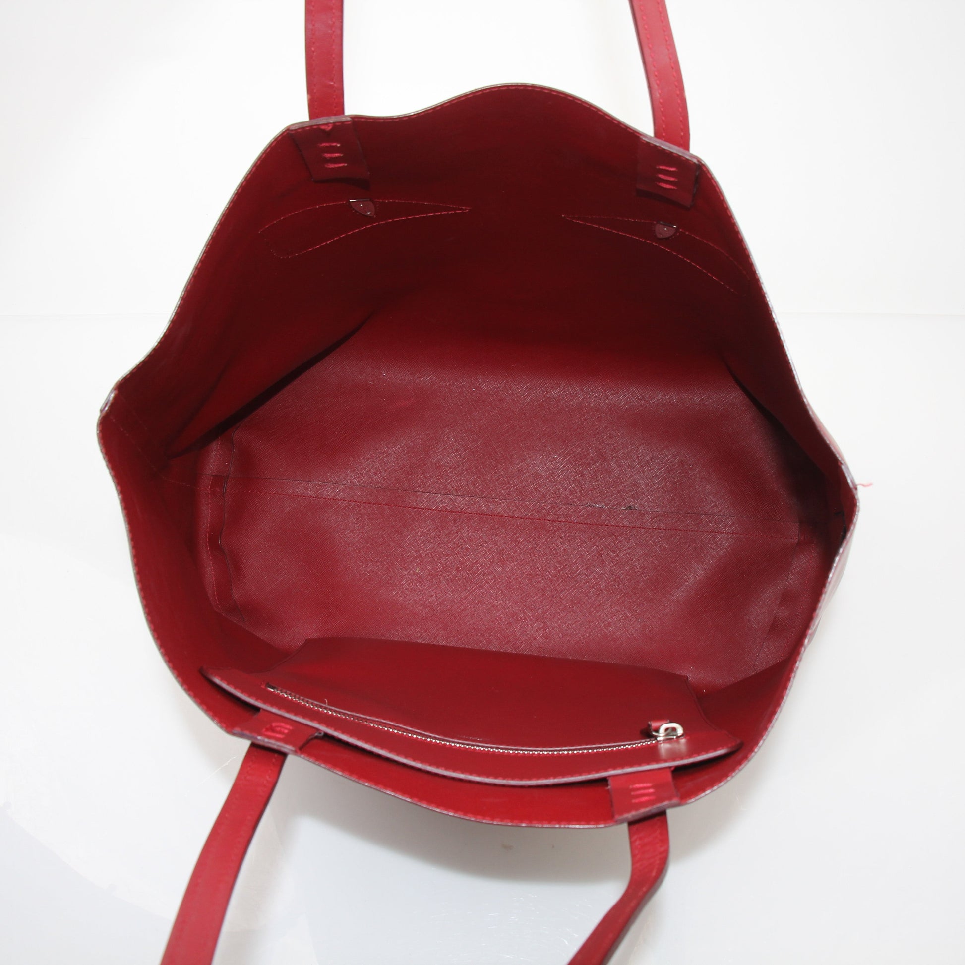 Red Fendi Monster Roll Tote Handbag with gold accents, featuring bold design and spacious interior for stylish carrying.
