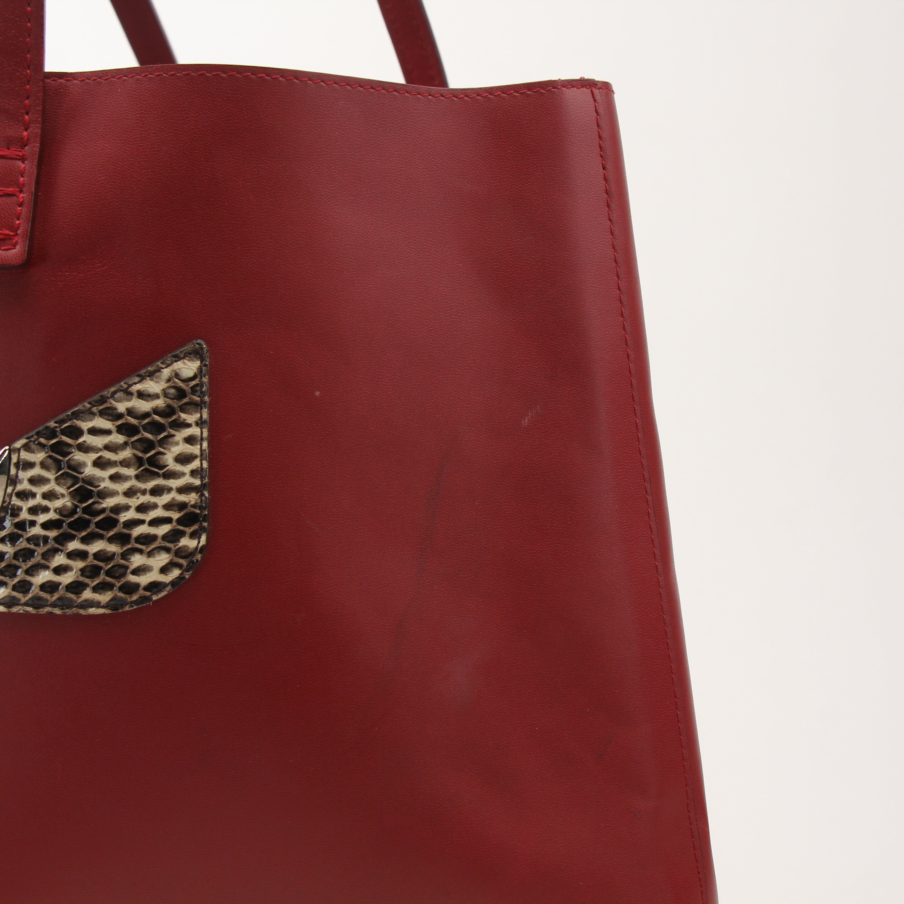 Red Monster Roll Tote Bag by Fendi, a stylish handbag with bold design, featuring red color and unique monster details.