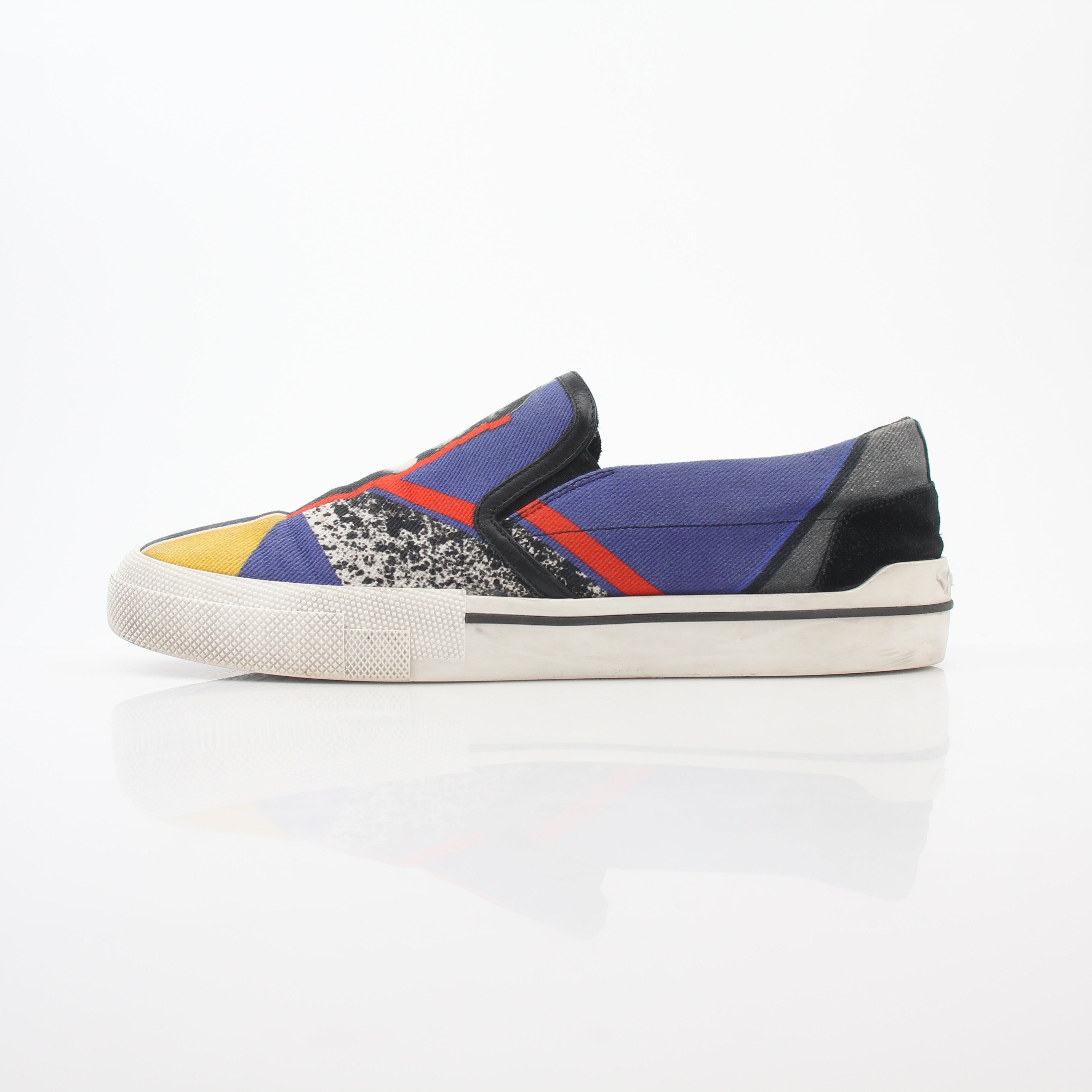 Gold & Beyond Versace men's graphic print canvas slip-on sneakers with bold design and comfortable fit, shown in the image.
