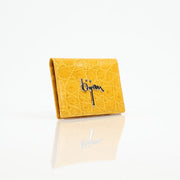 Gold & Beyond Bijan yellow crocodile leather wallet with textured finish, featuring multiple card slots and a sleek, compact design.