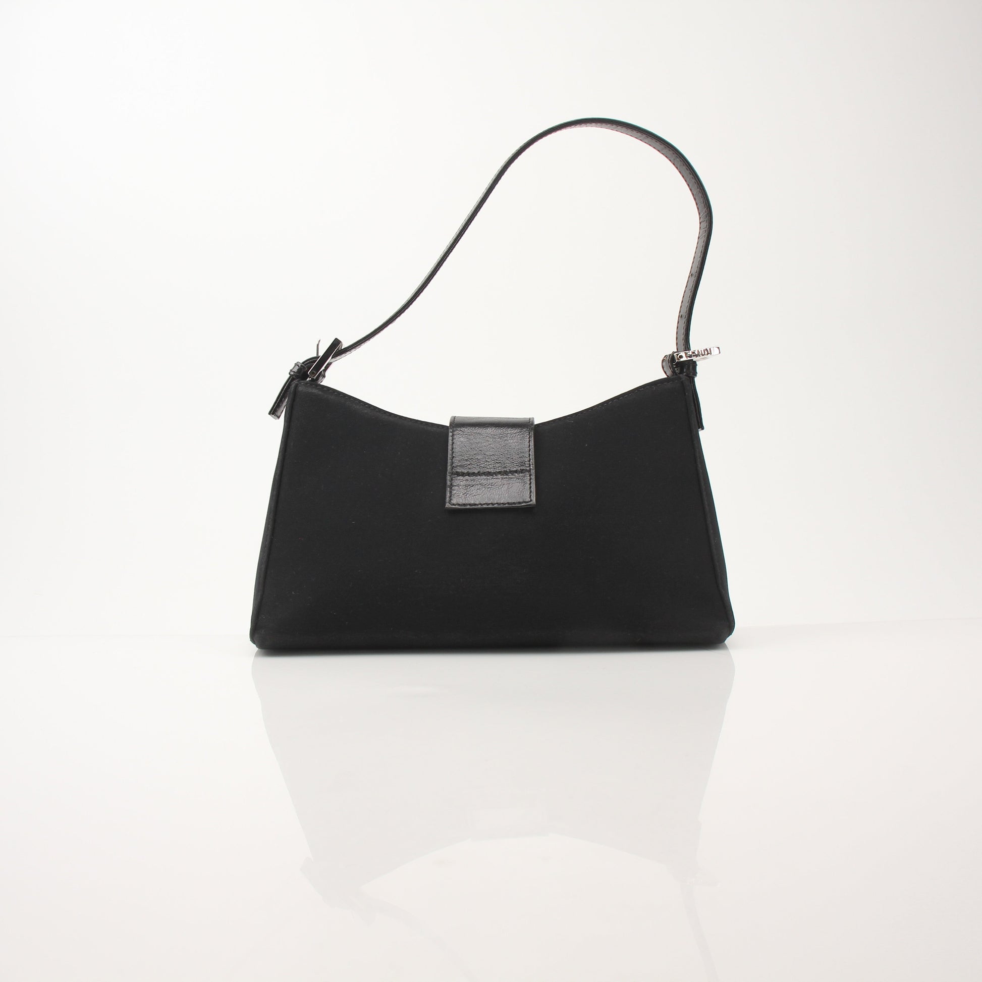 Black neoprene Fendi Baguette shoulder handbag with gold-tone hardware and signature design, carried on a model's shoulder.