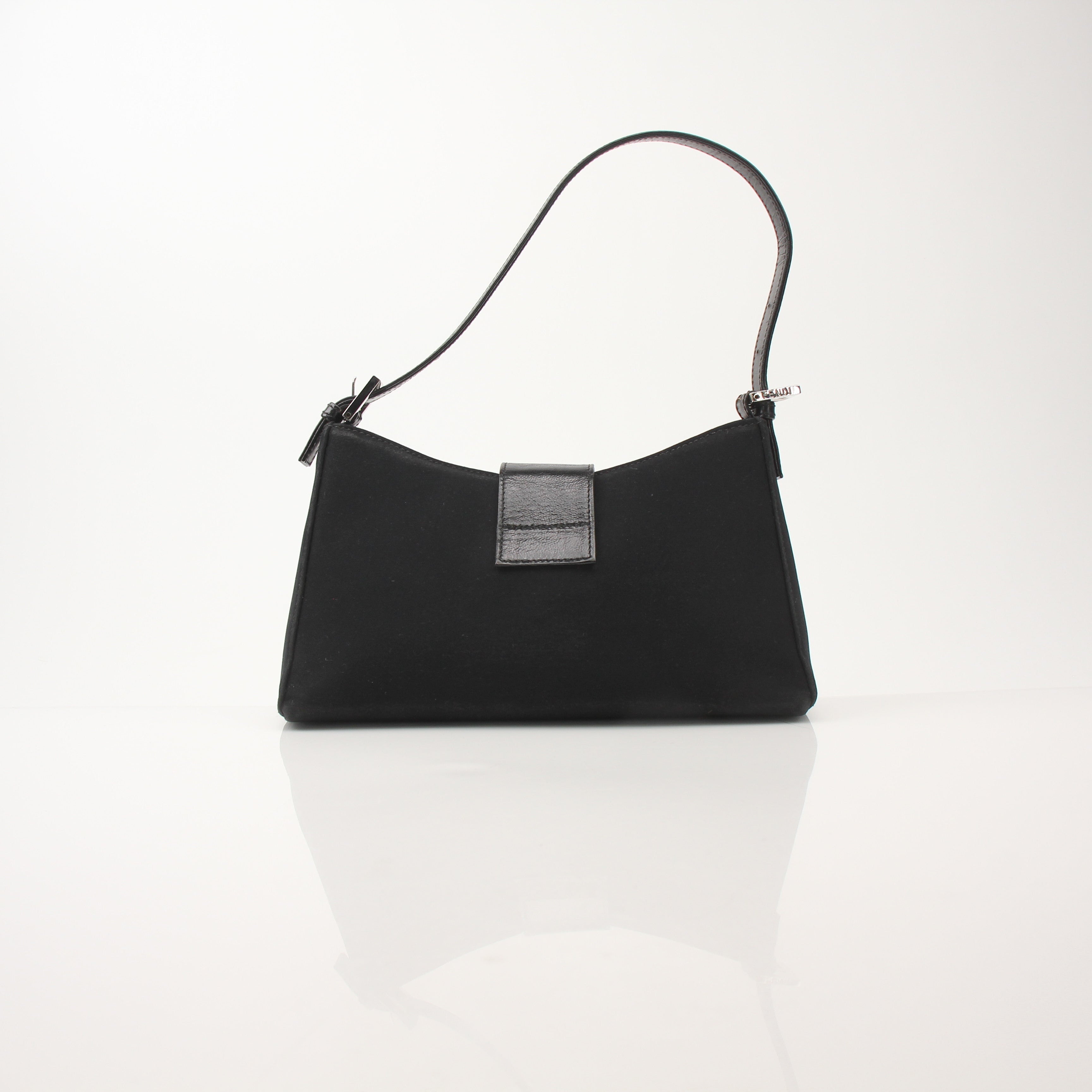 Black neoprene Fendi Baguette shoulder handbag with gold-tone hardware and signature design, carried on a model's shoulder.