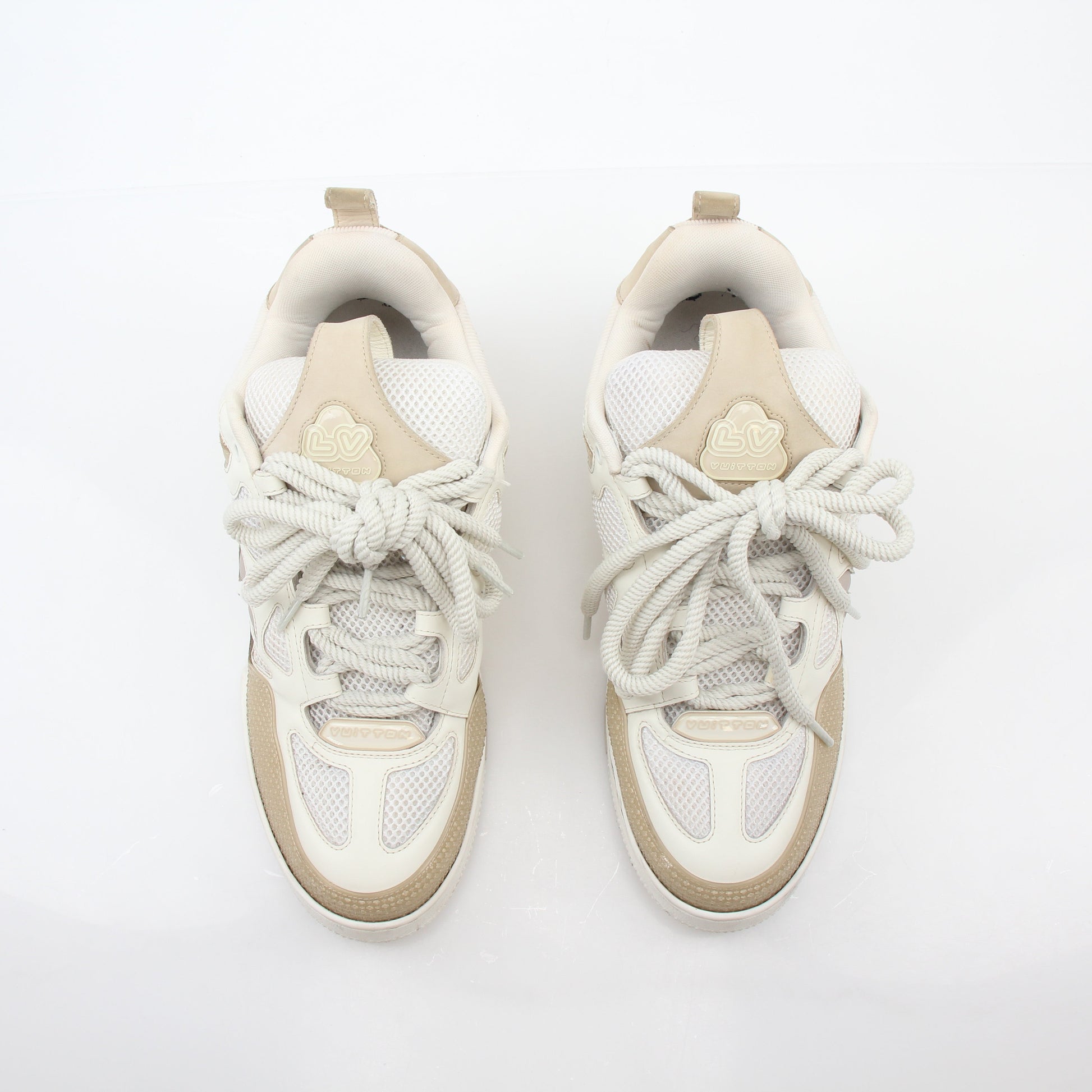 Louis Vuitton men's LV Skate sneaker in beige, stylish casual shoes with brand logo and laces, on clean white background.