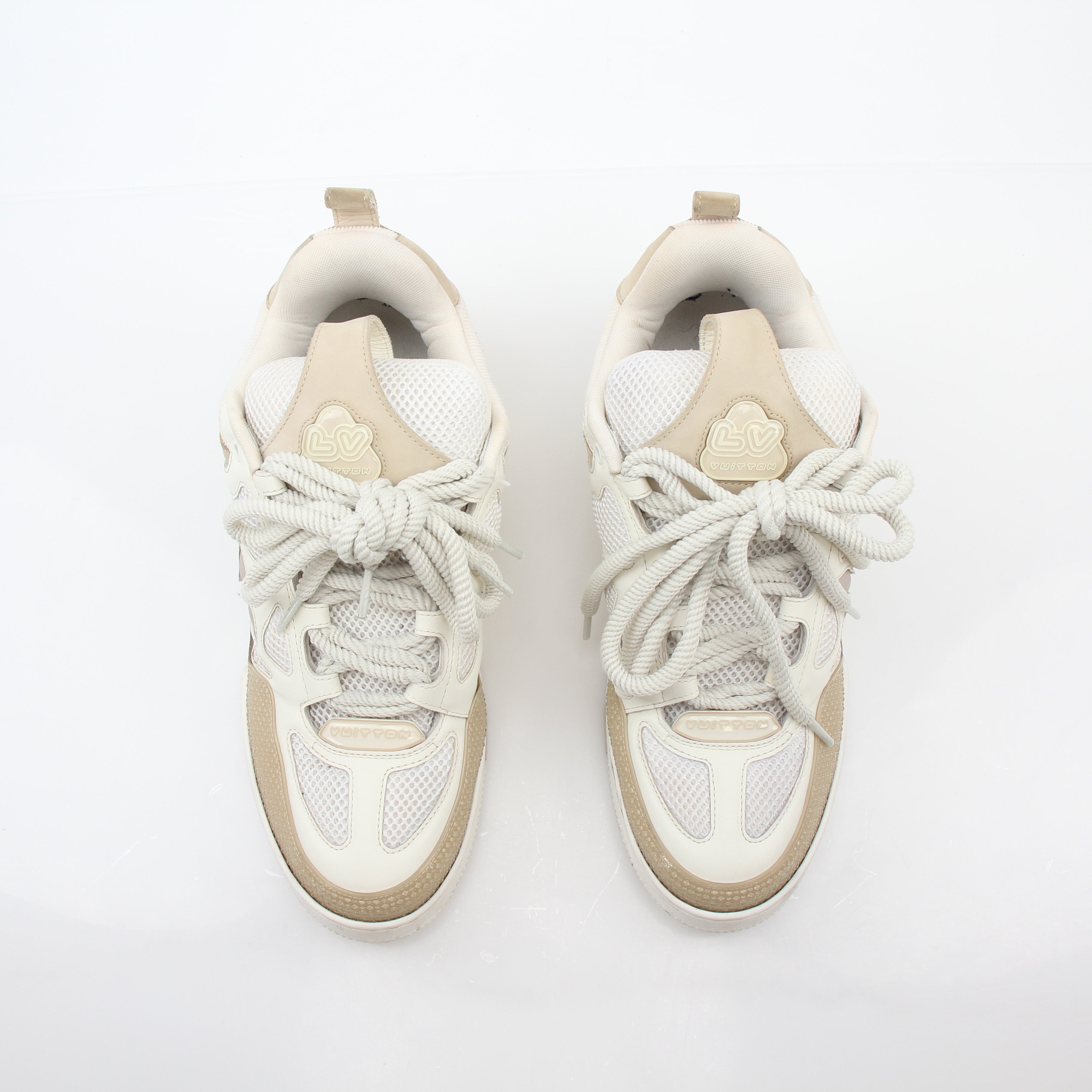 Louis Vuitton men's LV Skate sneaker in beige, stylish casual shoes with brand logo and laces, on clean white background.