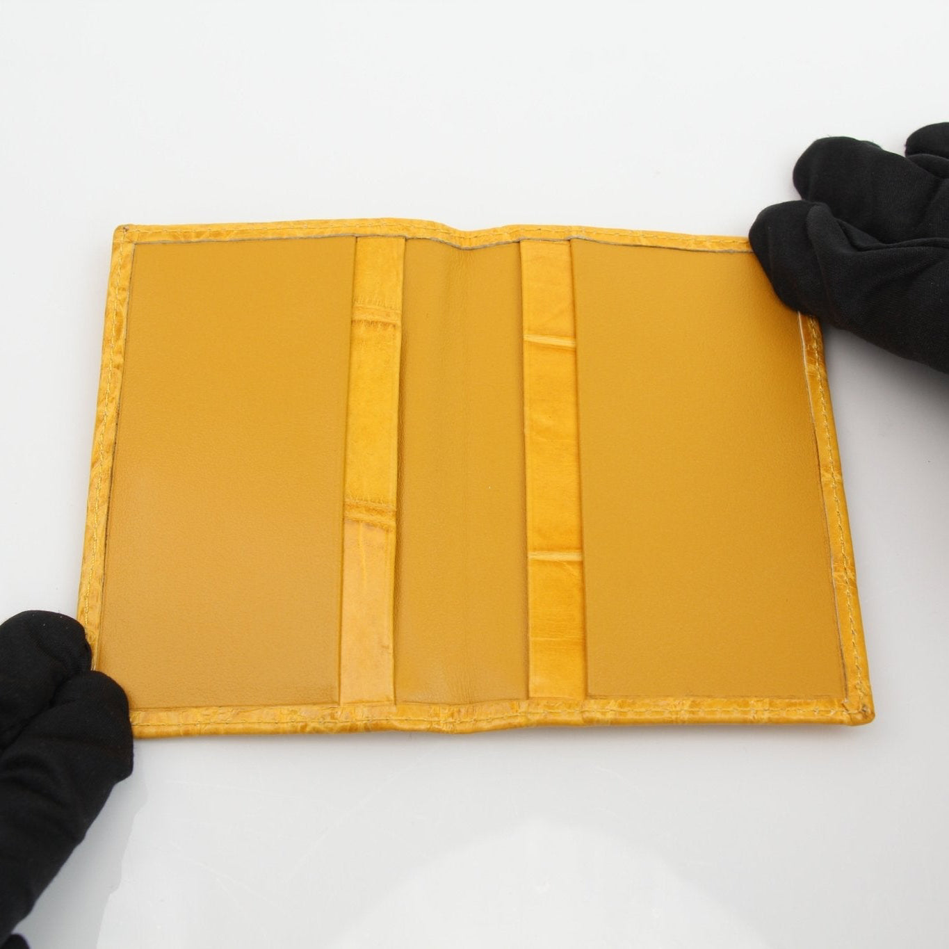 Gold & Beyond Bijan yellow crocodile wallet with textured leather exterior and multiple card slots.
