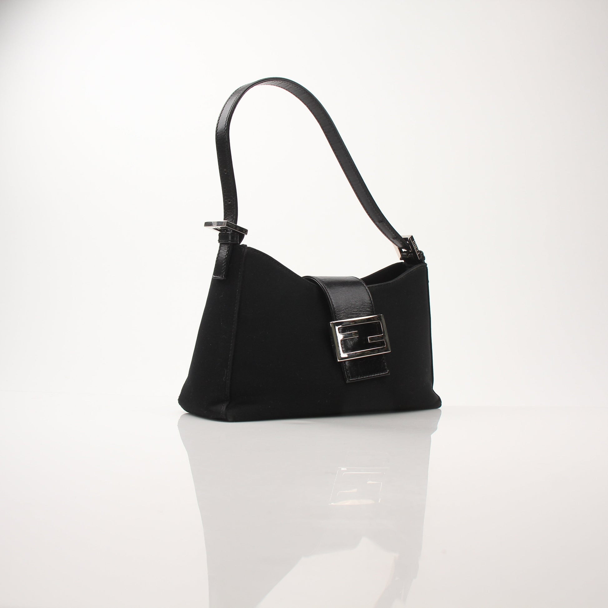 Black neoprene Fendi Baguette shoulder handbag with gold-tone accents, stylishly displayed on a neutral background.