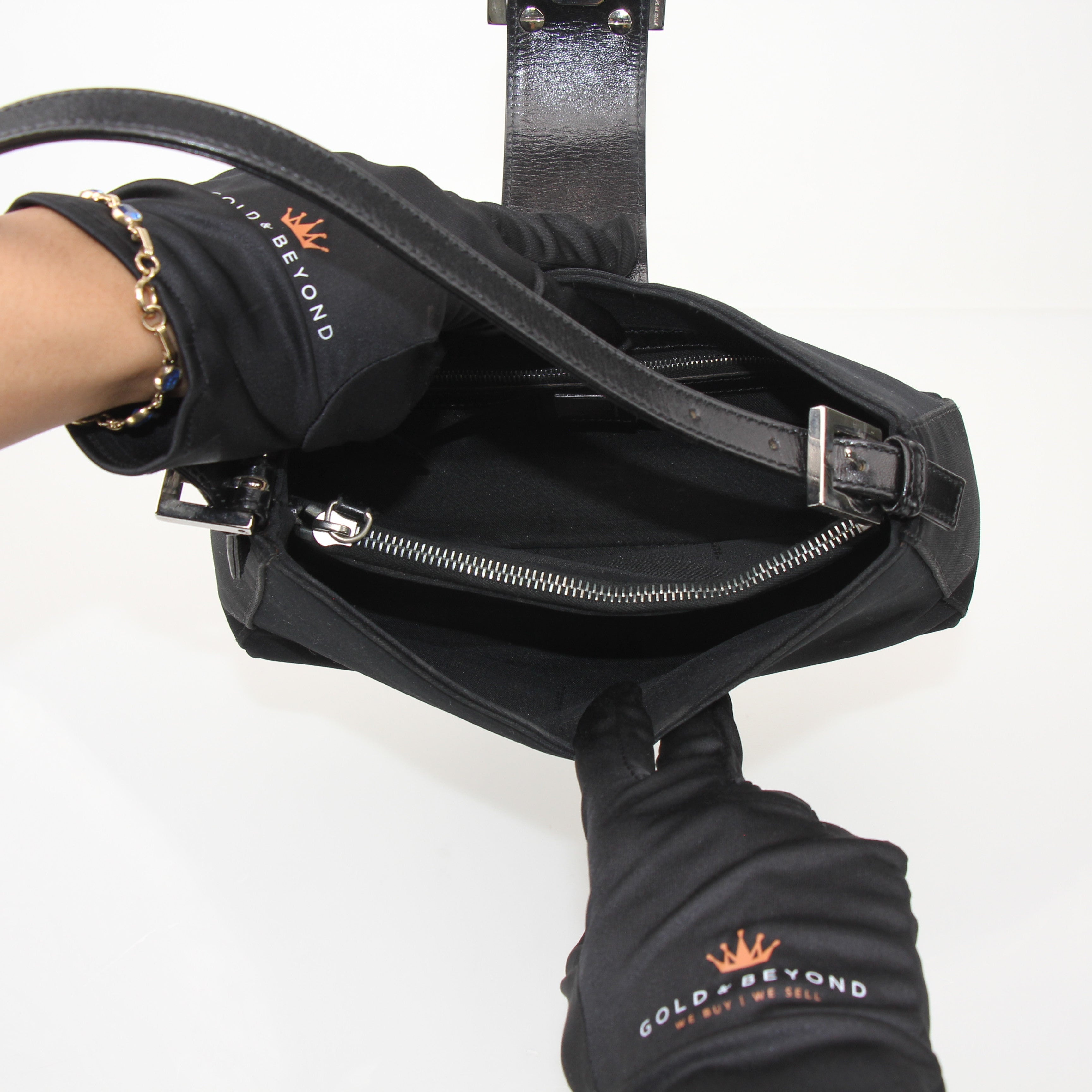 Fendi black neoprene baguette shoulder bag with gold-tone accents, featuring a sleek, compact handbag design.