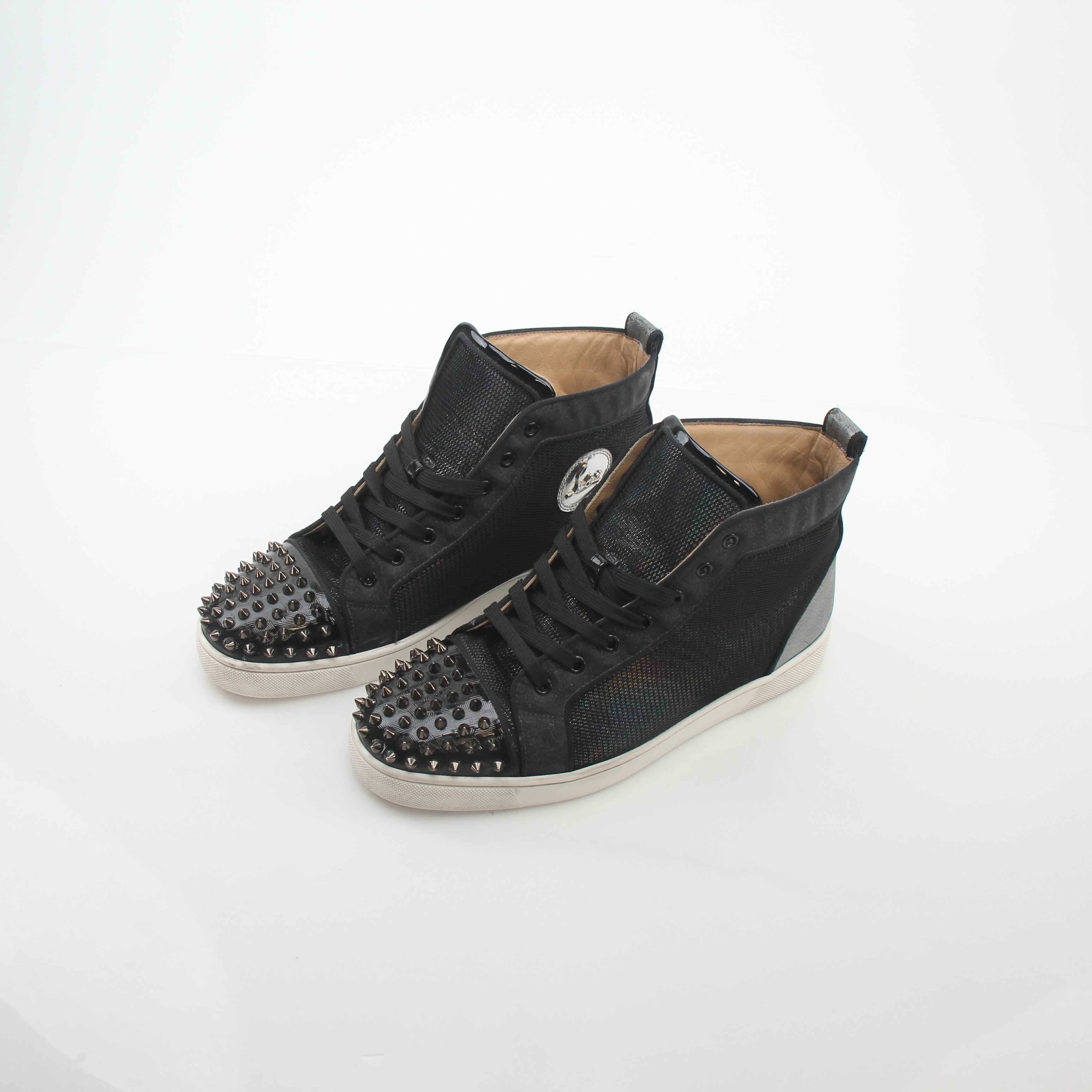 Black Christian Louboutin Lou Spikes Orlato high-top sneakers with red soles and spike details, displayed on a plain background.