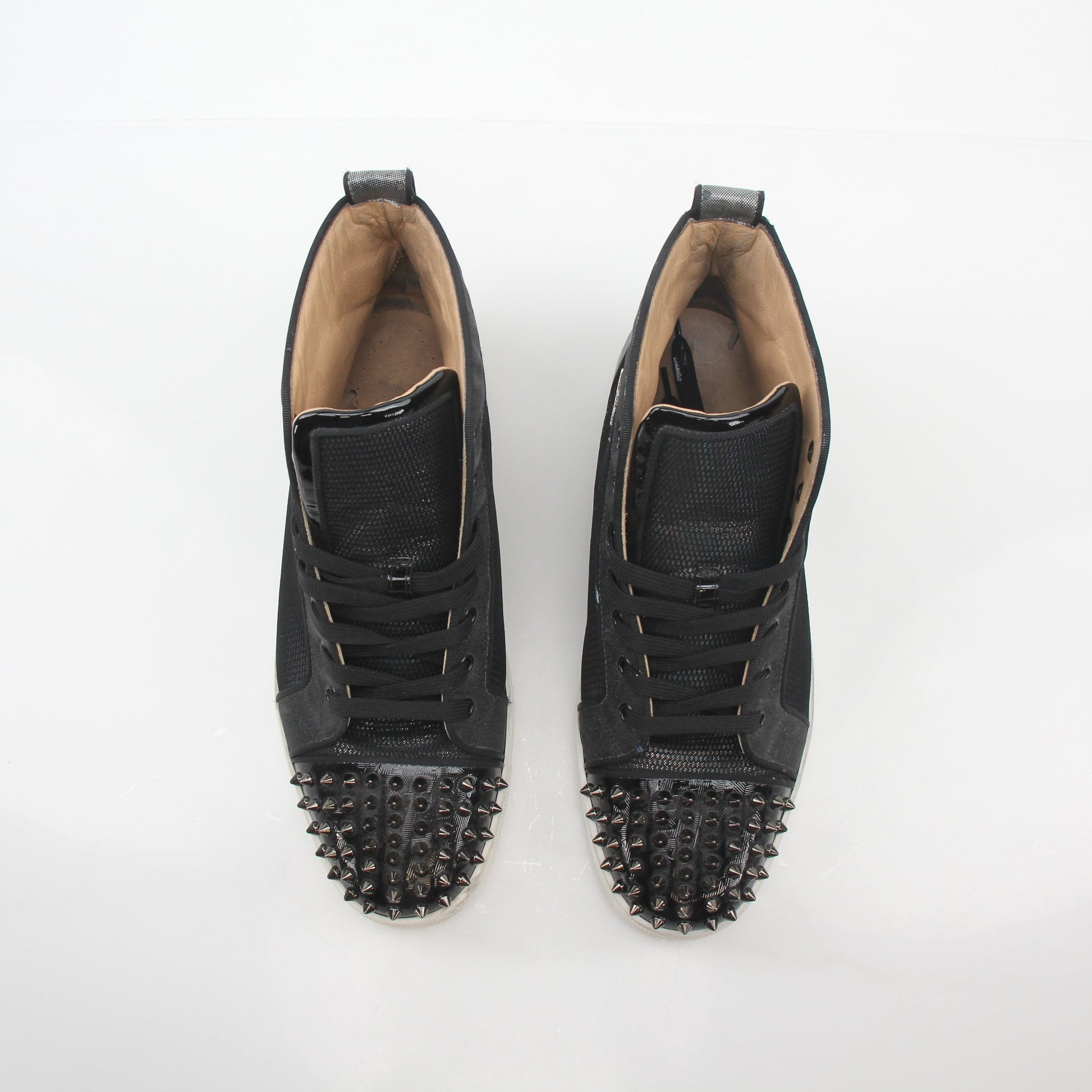 Christian Louboutin men's Lou Spikes Orlato black high-top sneakers with signature red soles and spike embellishments.