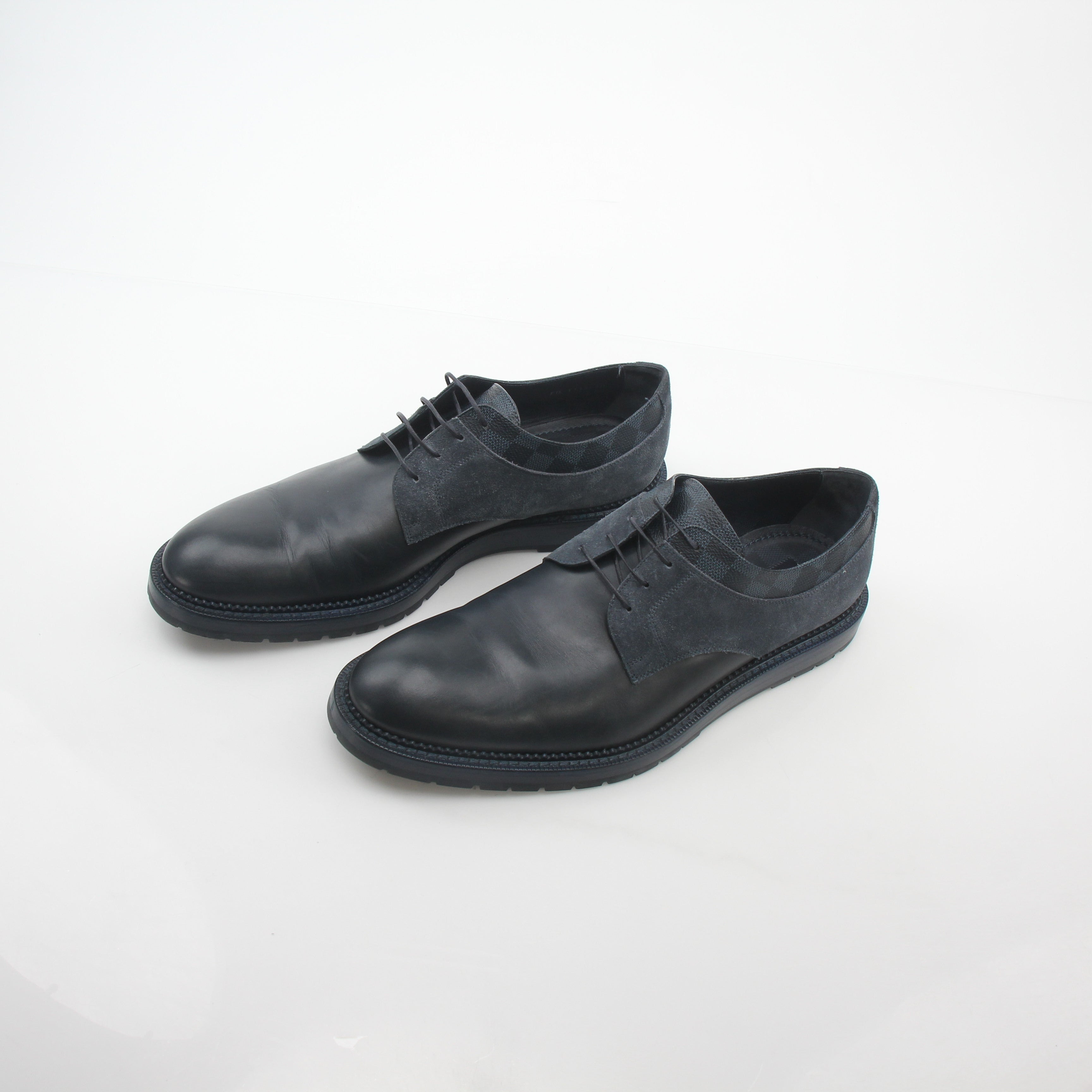 Louis Vuitton black and charcoal Damier suede Derby shoes with laces and sleek design, displayed on a neutral background.