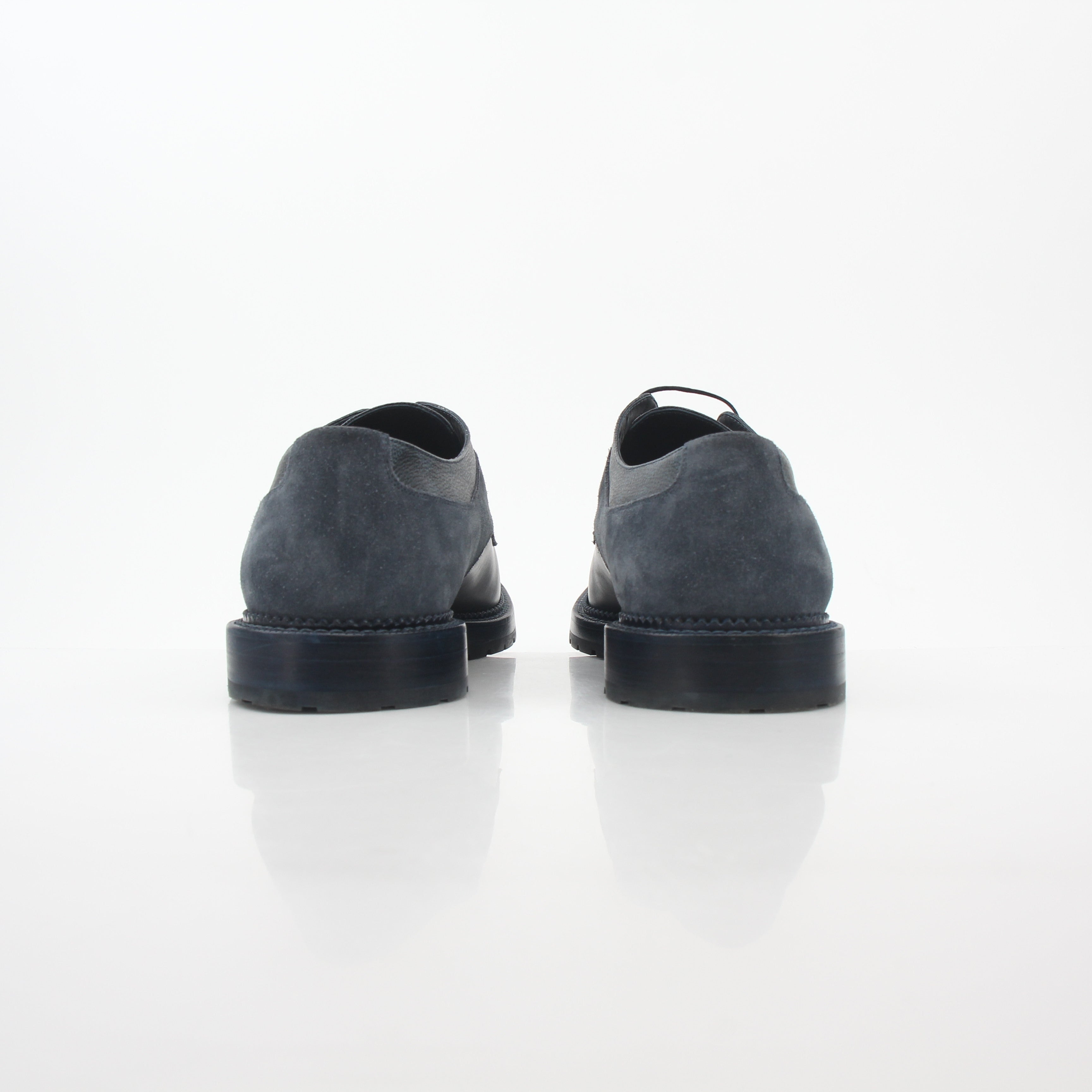 Louis Vuitton black and charcoal Damier suede derby shoes with classic lace-up design and sleek silhouette.