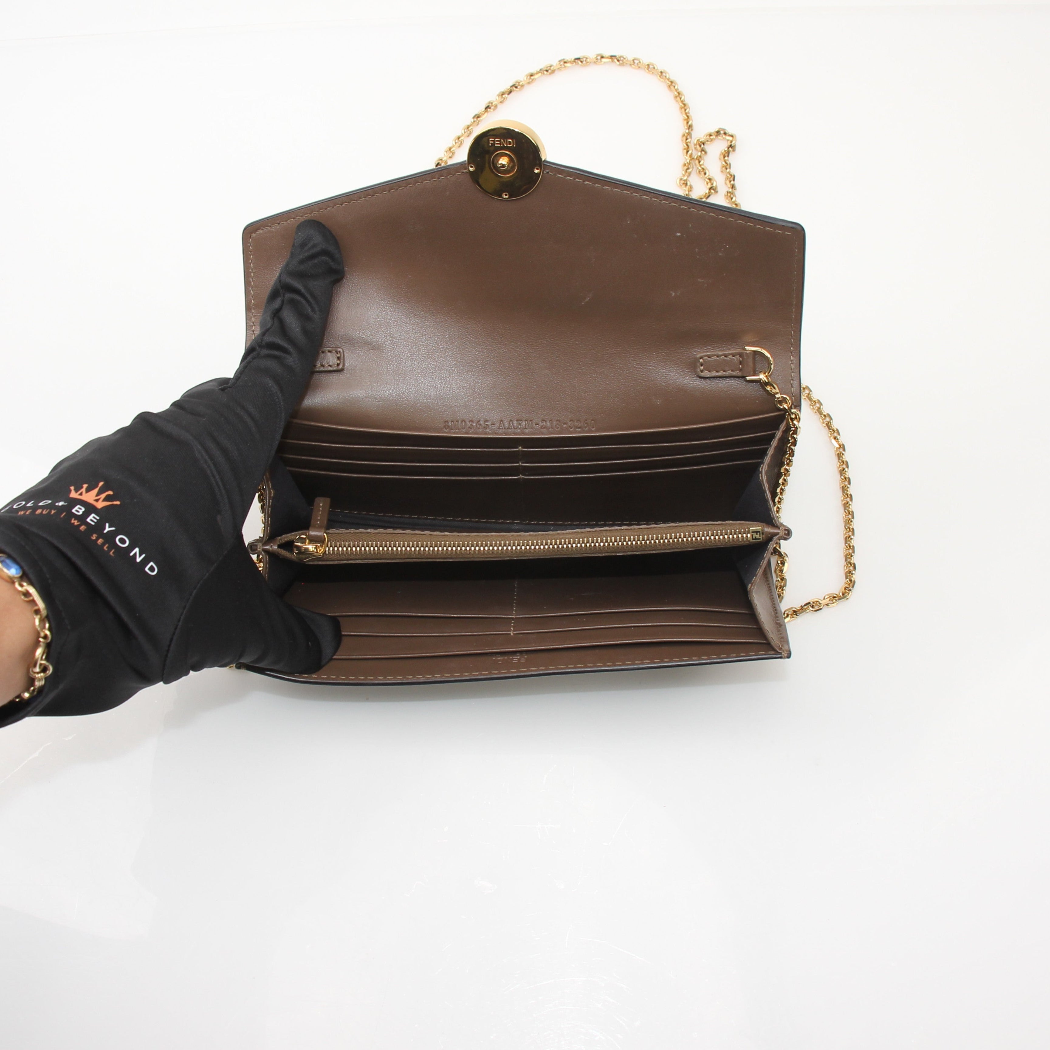 Fendi F Is Fendi leather continental envelope wallet on chain with gold hardware, black color, and logo details.