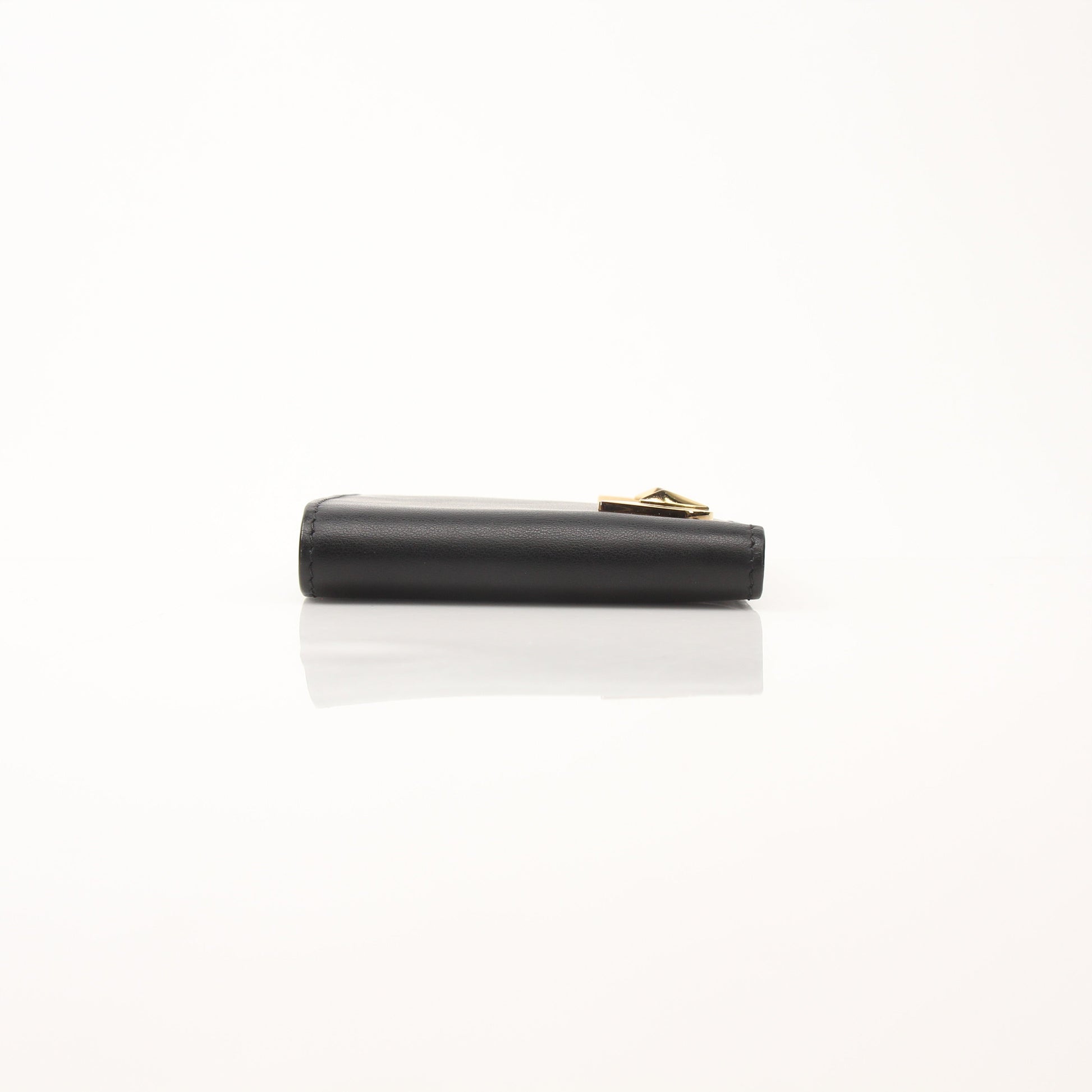 Fendi Vitello Century metal-eyed bi-fold wallet with textured leather and gold accents, featuring distinctive monster eye design.
