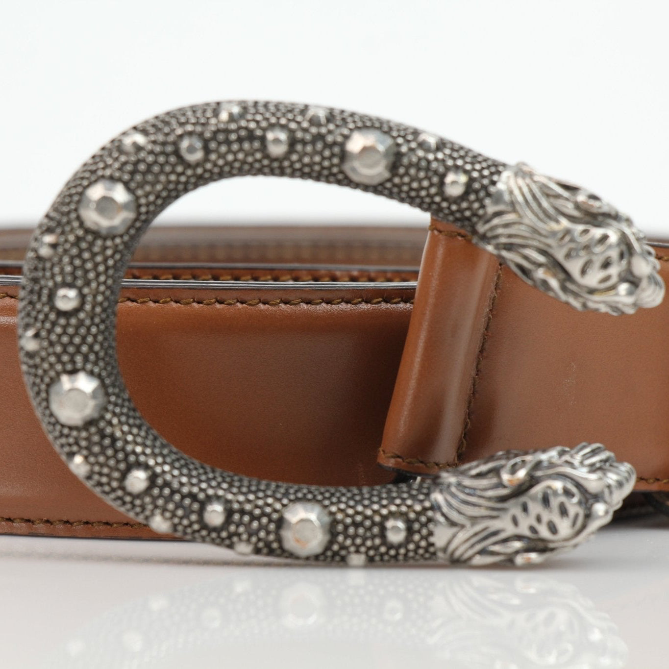 Brown Gucci Dionysus belt with gold-toned hardware, showcasing the signature GG logo and luxury leather details.