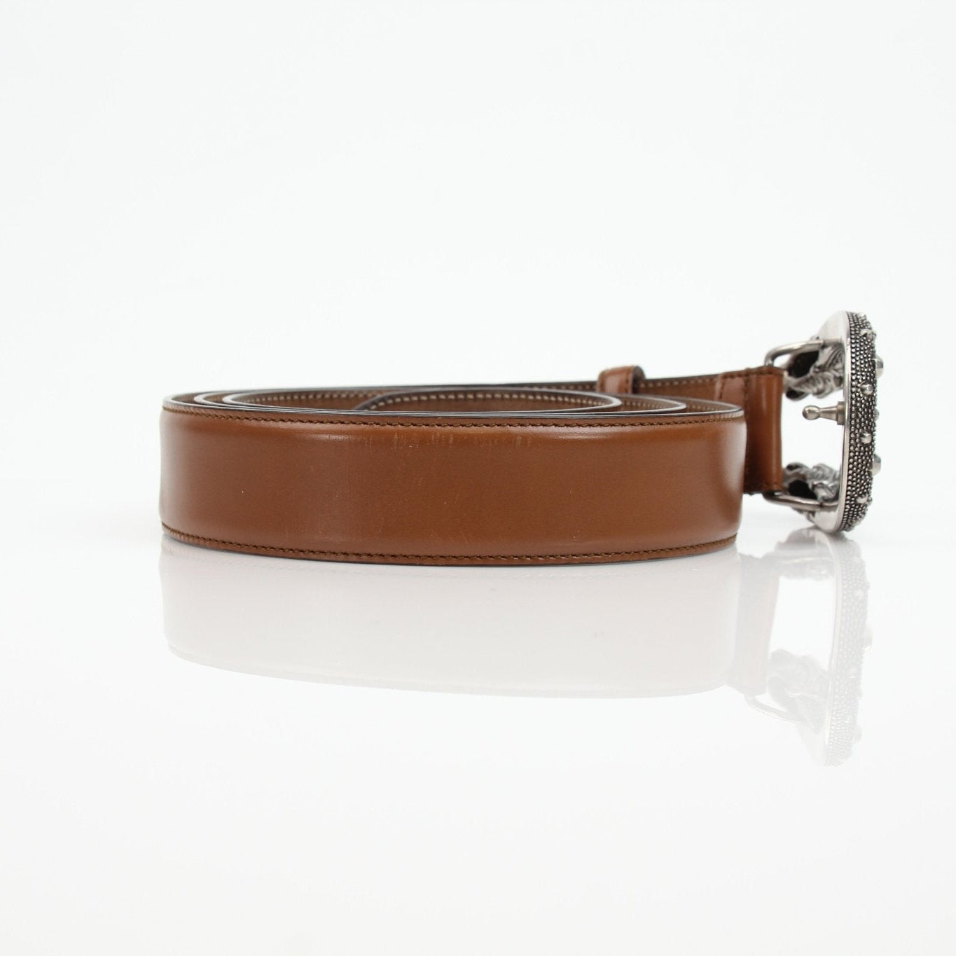 Brown Gucci Dionysus belt with gold-tone hardware, displayed on a neutral background, showcasing the luxury accessory's details.