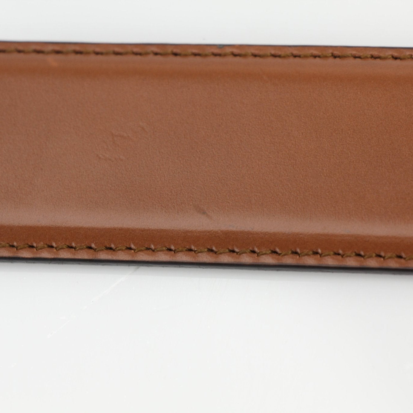 Gucci brown Dionysus belt with gold-tone hardware, luxury accessories displayed on a neutral background.