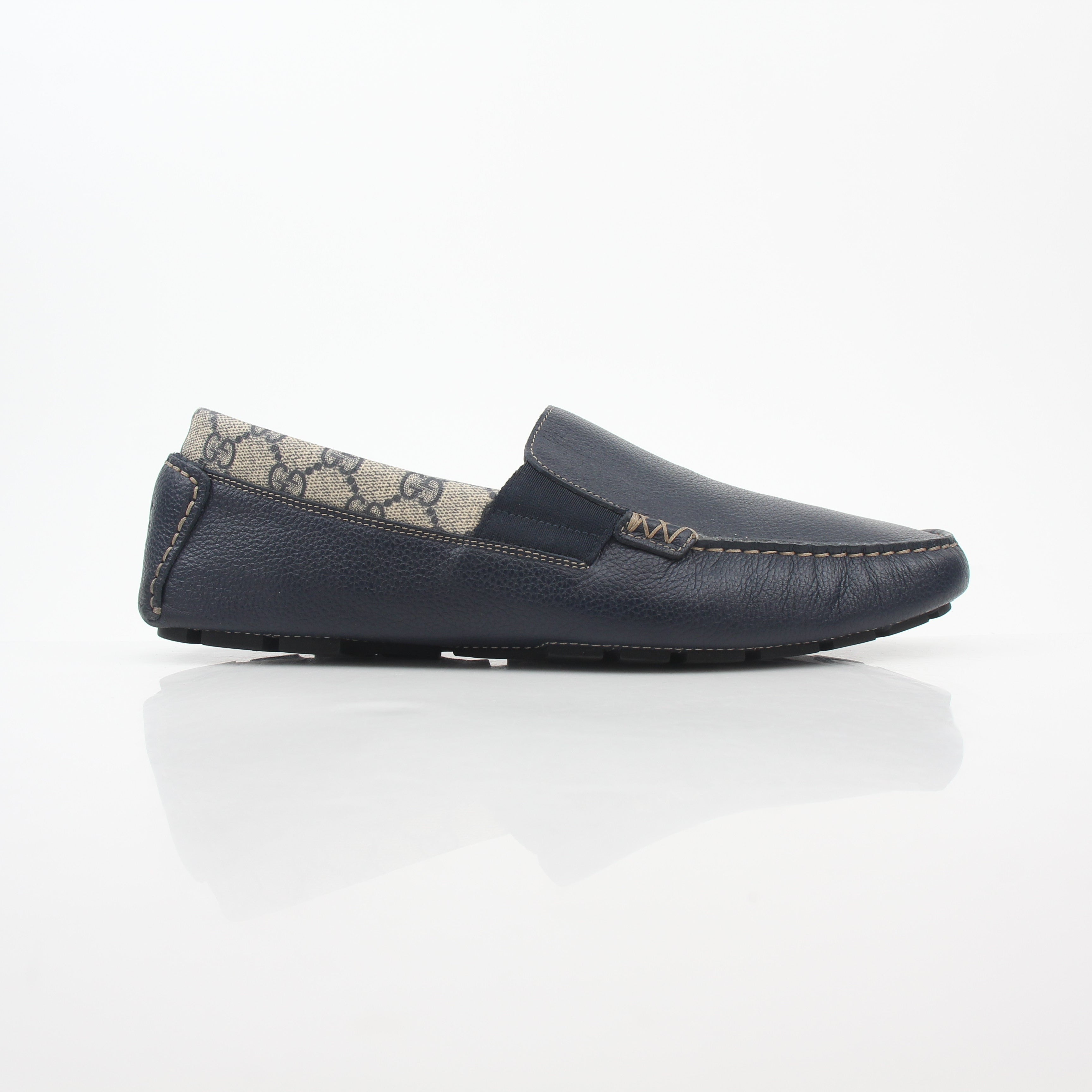 Gucci navy GG Supreme leather driver loafers with leather lining and rubber soles, stylish men's slip-on shoes.