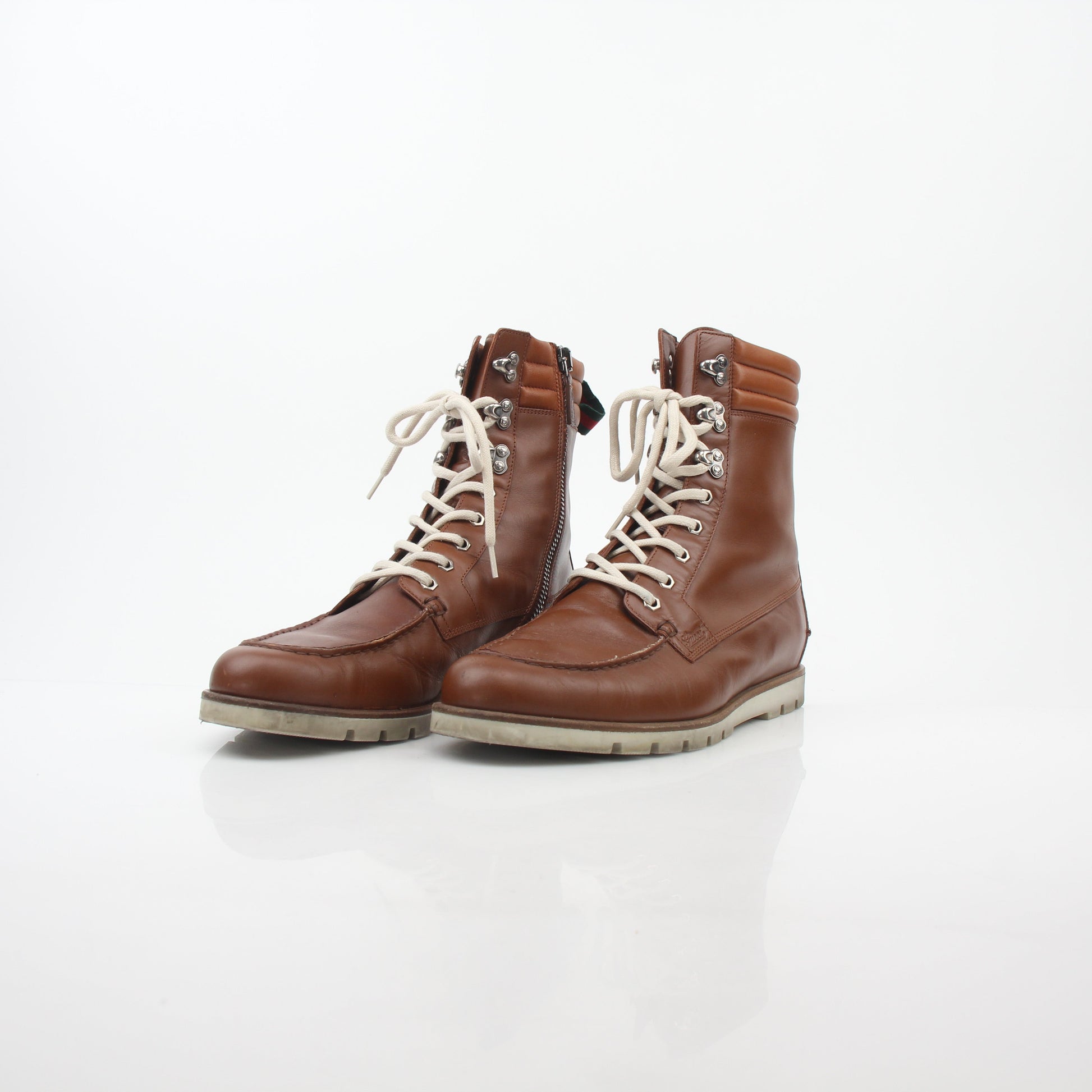 Gucci brown leather web accent hiking boots with rugged soles and stylish design, perfect for outdoor and casual wear.