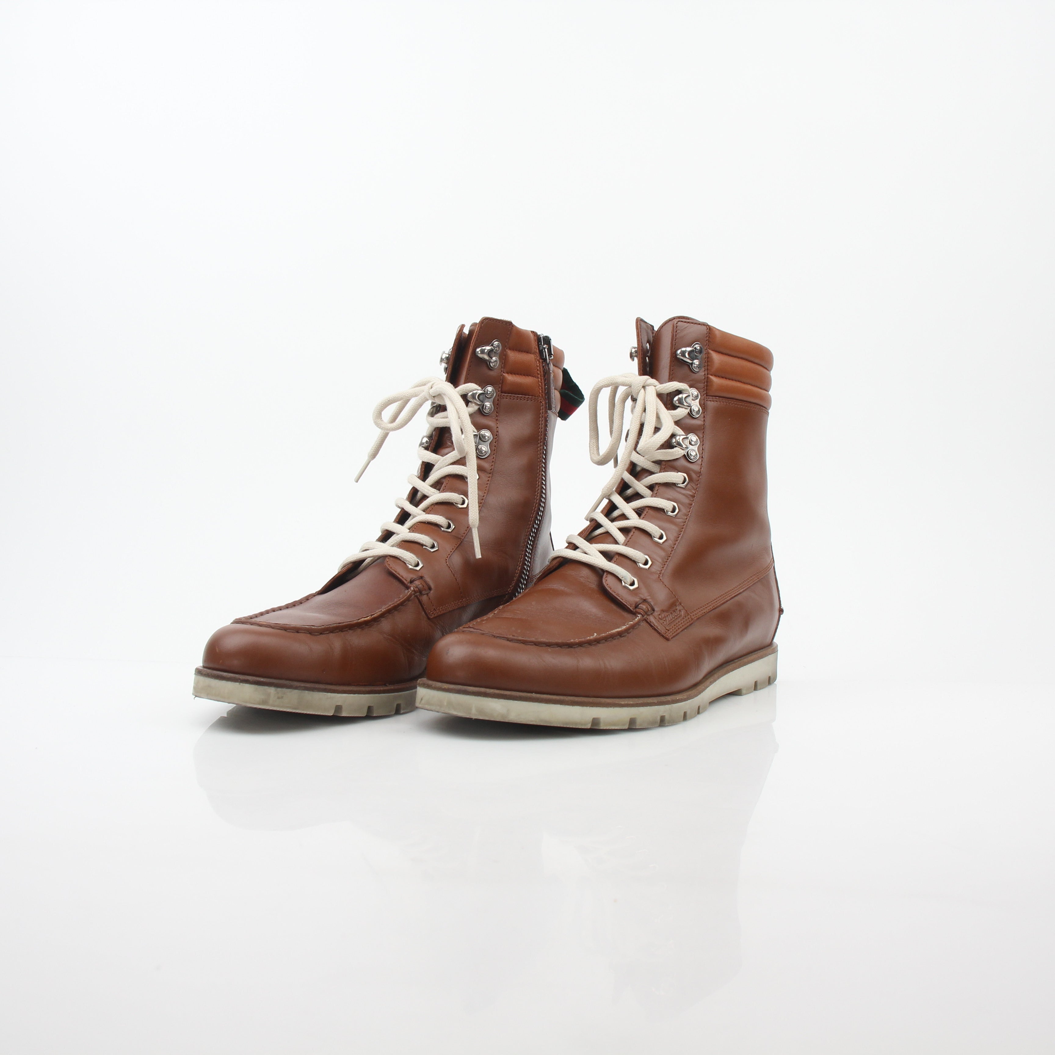 Gucci brown leather web accent hiking boots with rugged soles and stylish design, perfect for outdoor and casual wear.