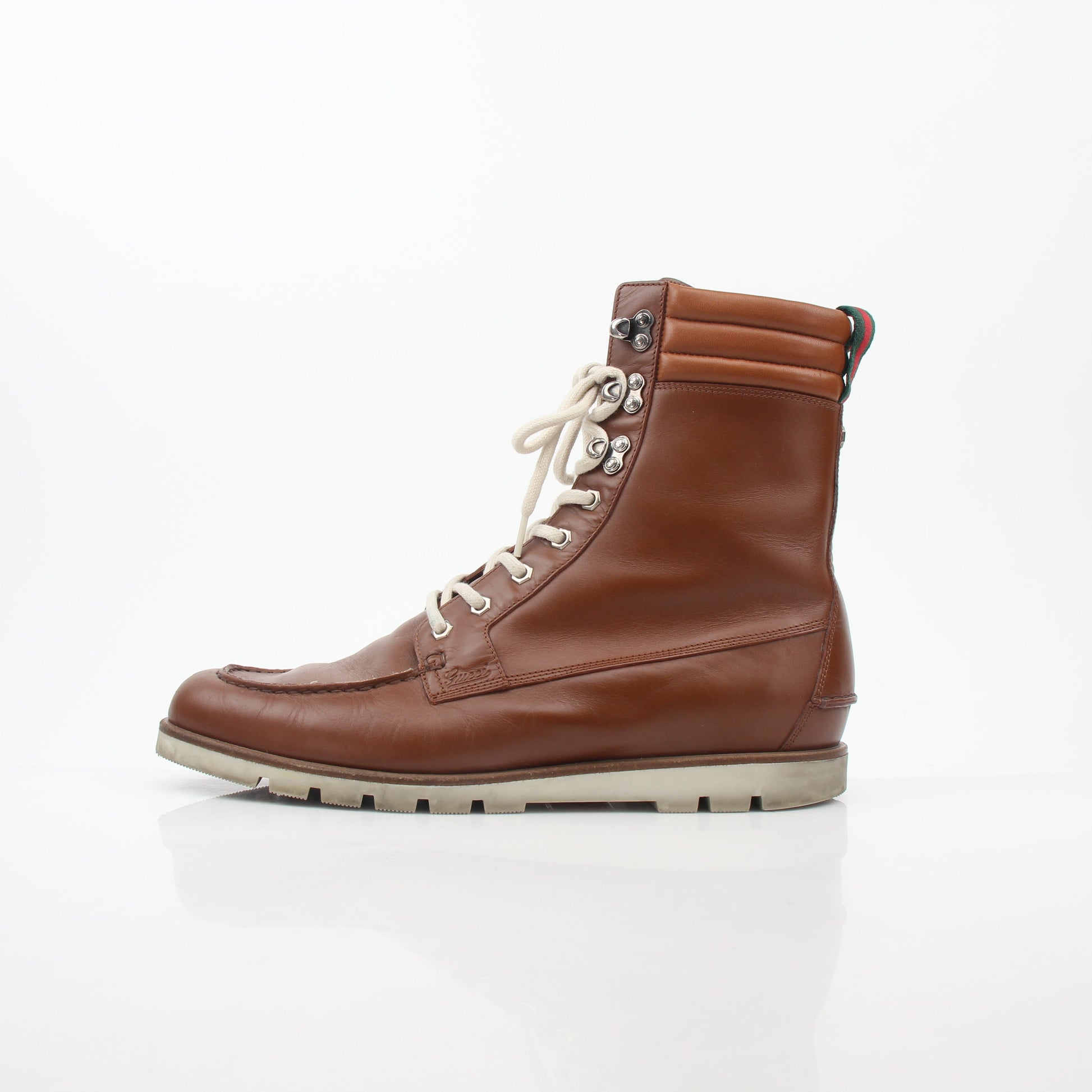 Gucci brown leather Web accent hiking boots with rugged soles and ankle support, stylish and durable shoes for outdoor wear.