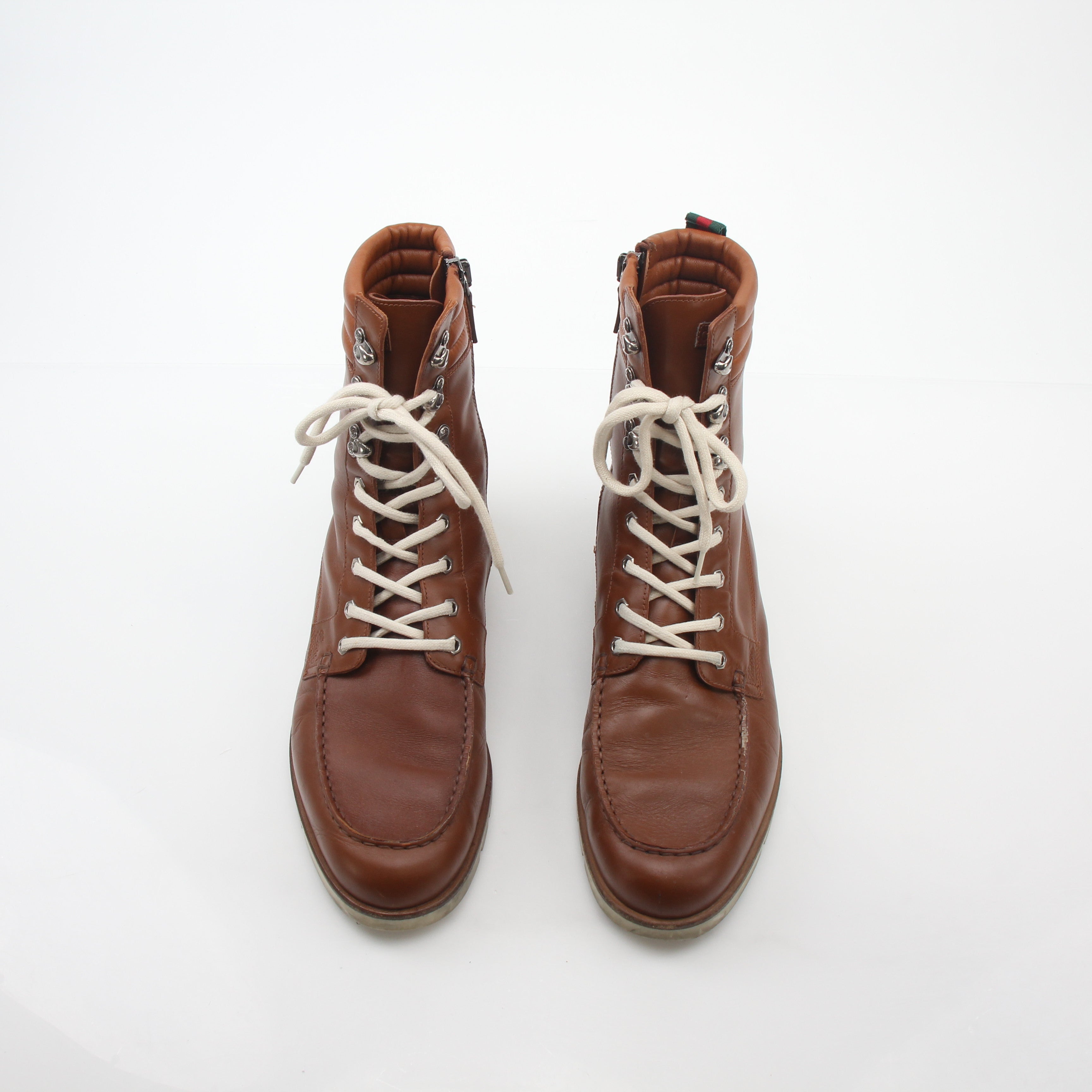 Gucci brown leather hiking boots with web accents, sturdy shoes with rugged soles and metal eyelets for outdoor wear.