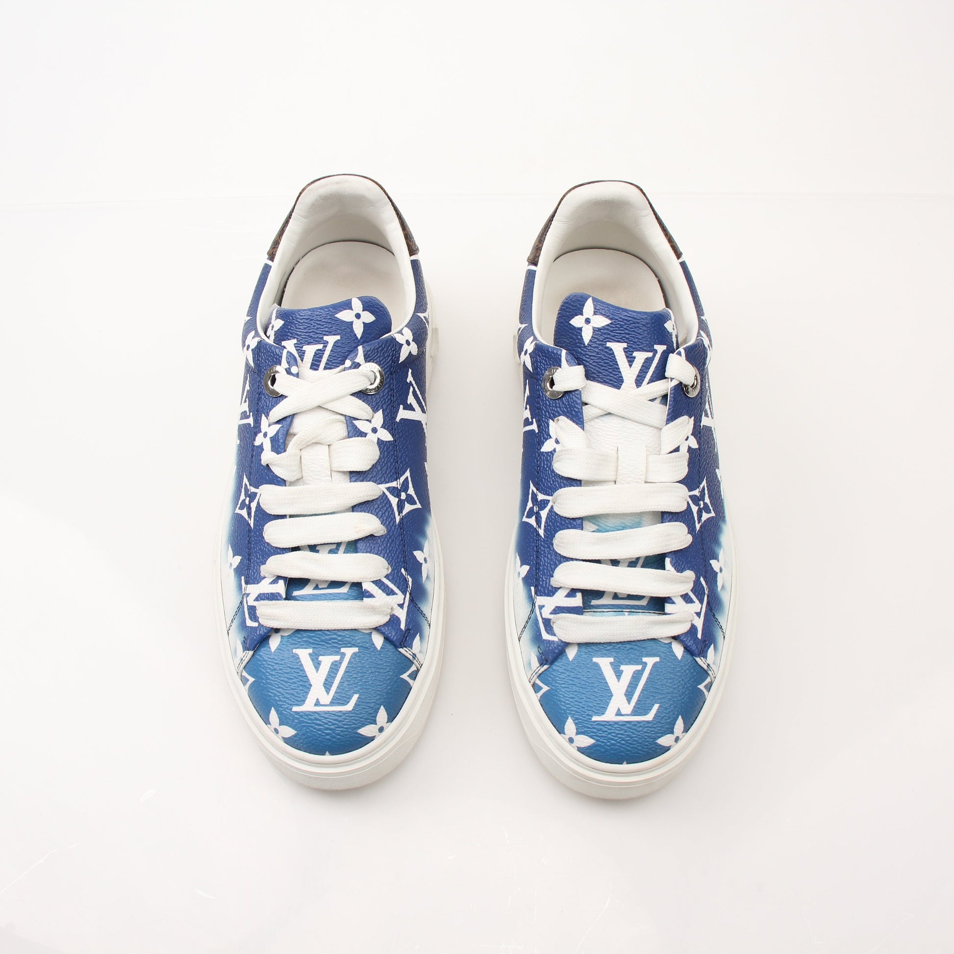 Louis Vuitton Women’s Time Out Sneakers by Gold & Beyond, stylish white shoes with Louis Vuitton branding and sporty design.
