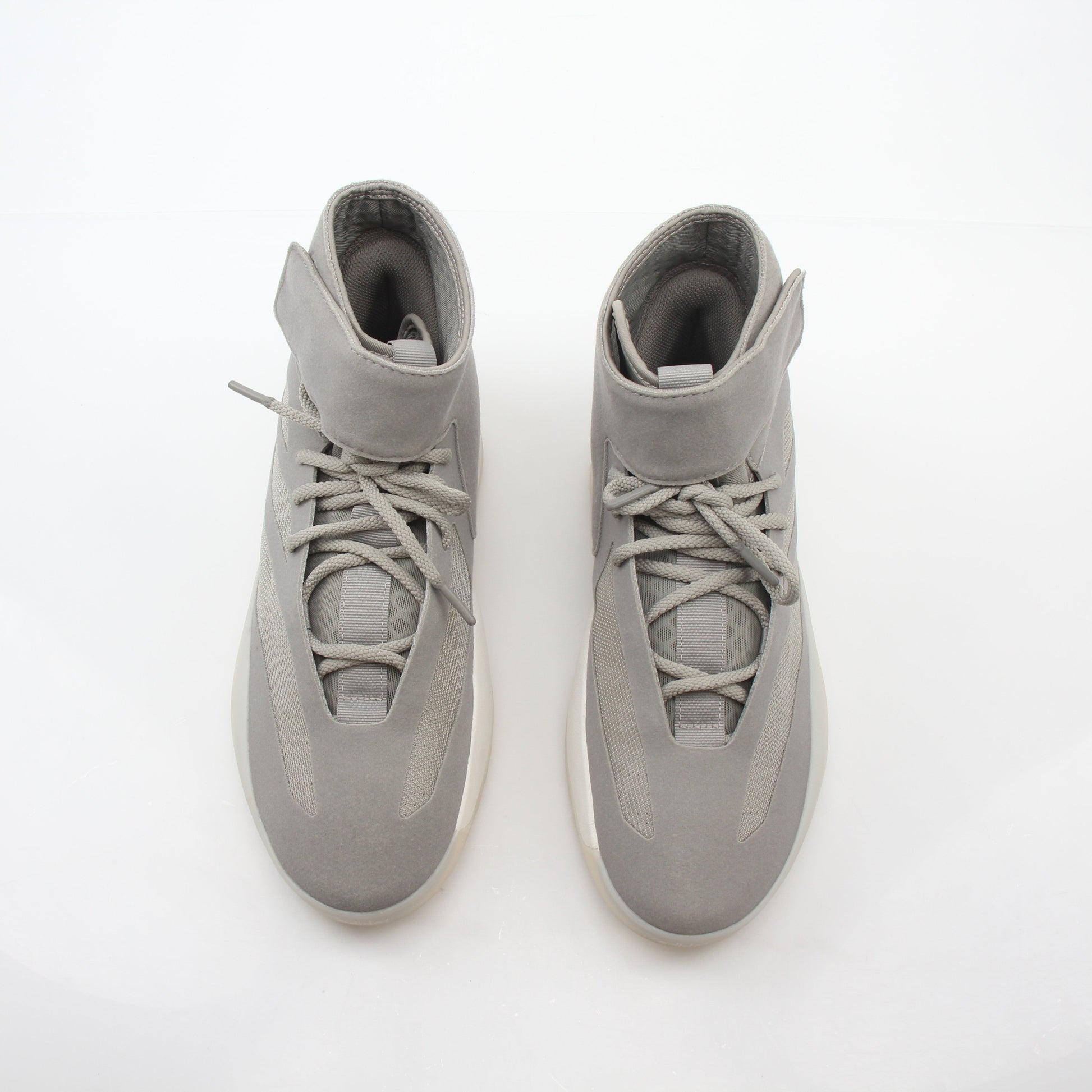 Beige Adidas x Fear of God Putty Athletics II basketball sneakers with high-top design and gold accents, displayed on a plain background.