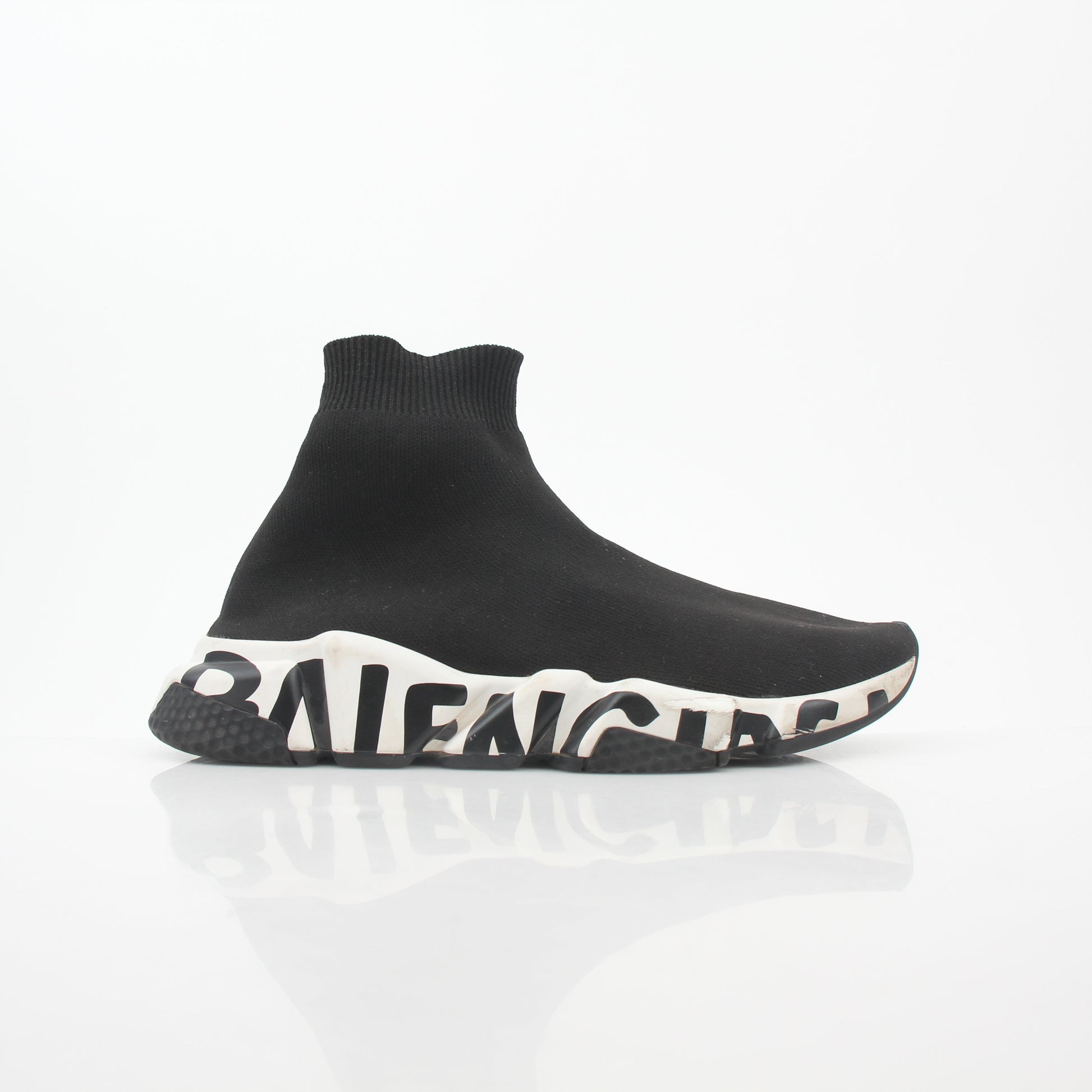 Black Speed Graffiti Sock Sneakers by Balenciaga featuring bold graffiti design and sock-like fit, shown on a model's feet.