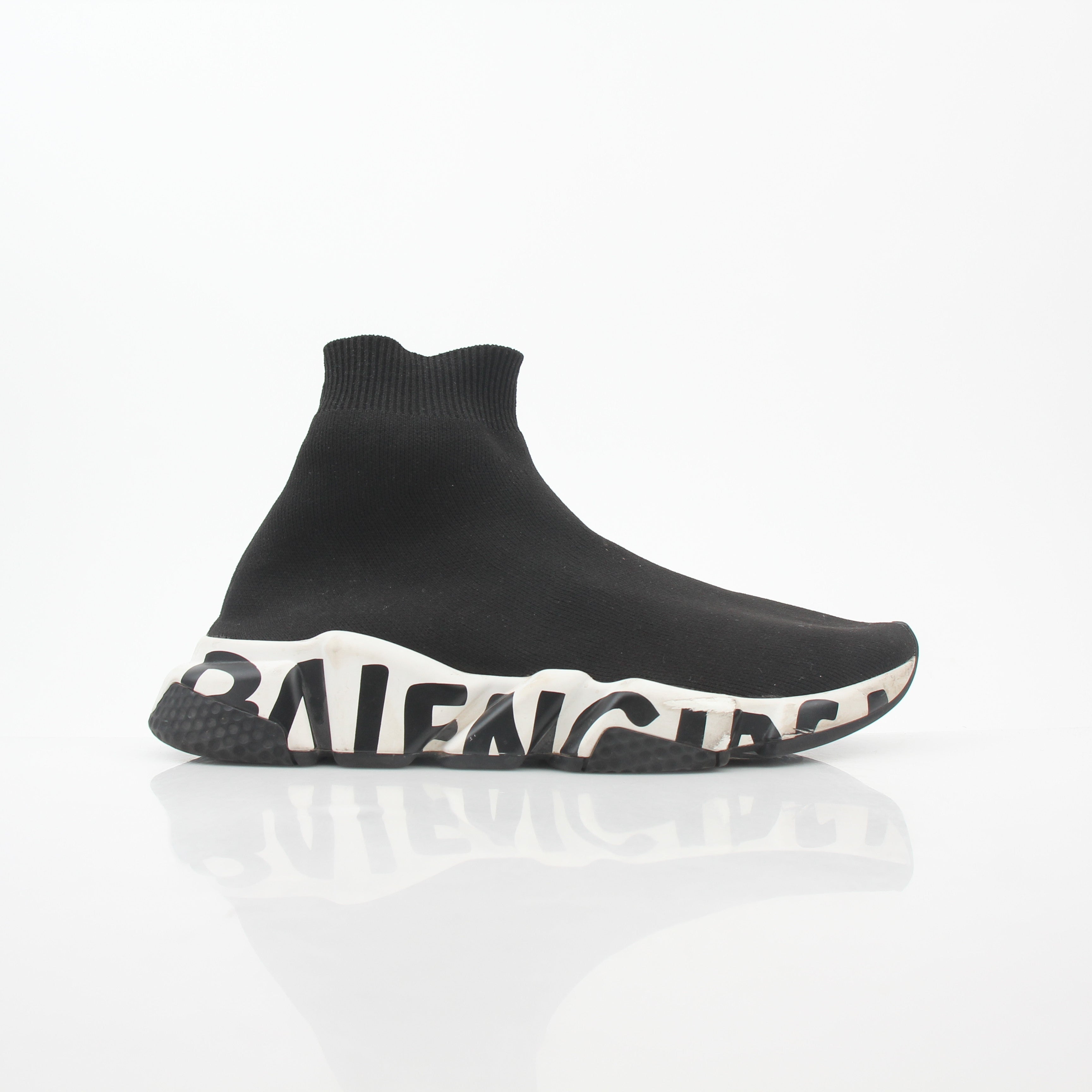 Black Speed Graffiti Sock Sneakers by Balenciaga featuring bold graffiti design and sock-like fit, shown on a model's feet.