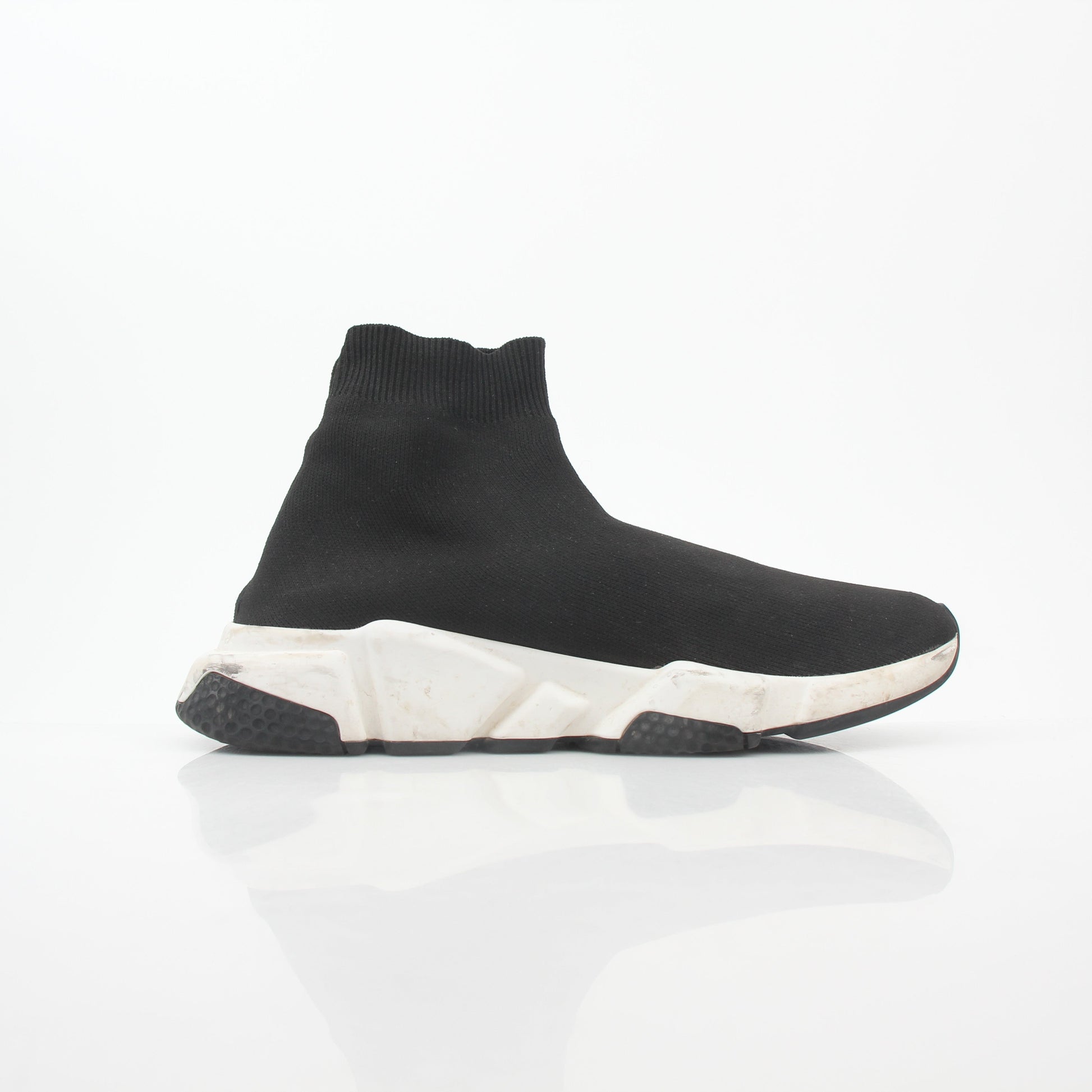Black Speed Graffiti Sock Sneakers by Balenciaga, featuring bold graffiti design and sleek sock-style fit, worn on a fashion-forward foot.