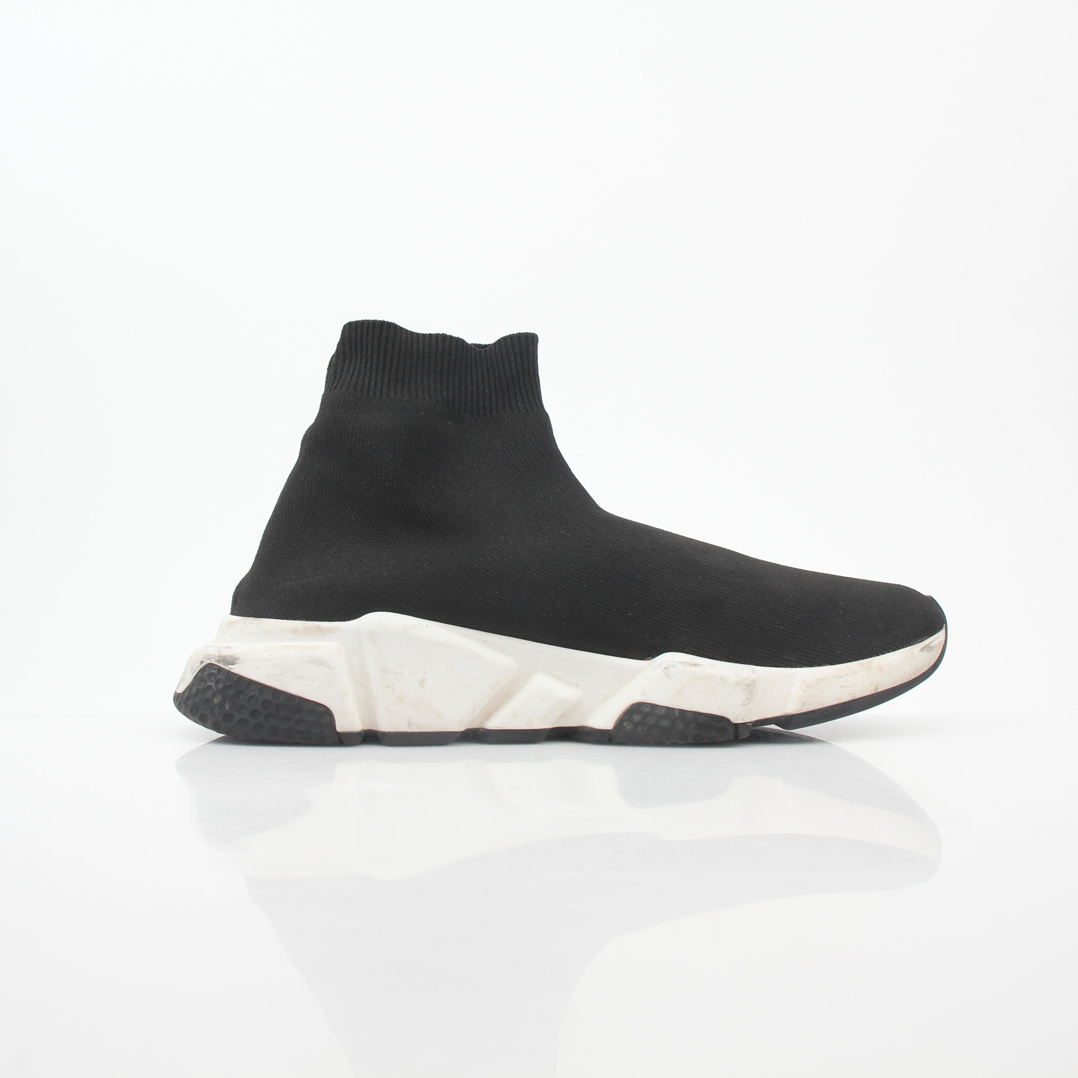 Black Speed Graffiti Sock Sneakers by Balenciaga, featuring bold graffiti design and sleek sock-style fit, worn on a fashion-forward foot.