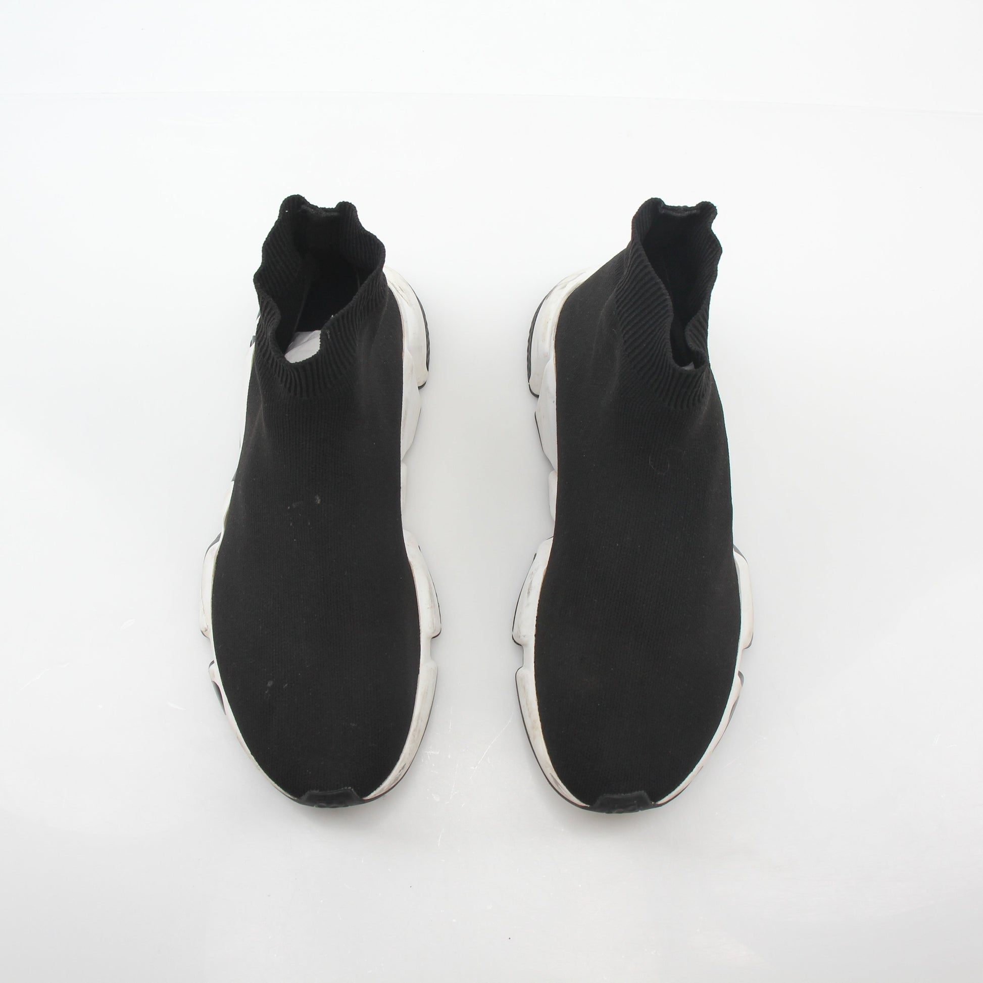 Black Balenciaga Speed Graffiti Sock Sneakers with bold graffiti design and sleek athletic style, worn on a model's feet.