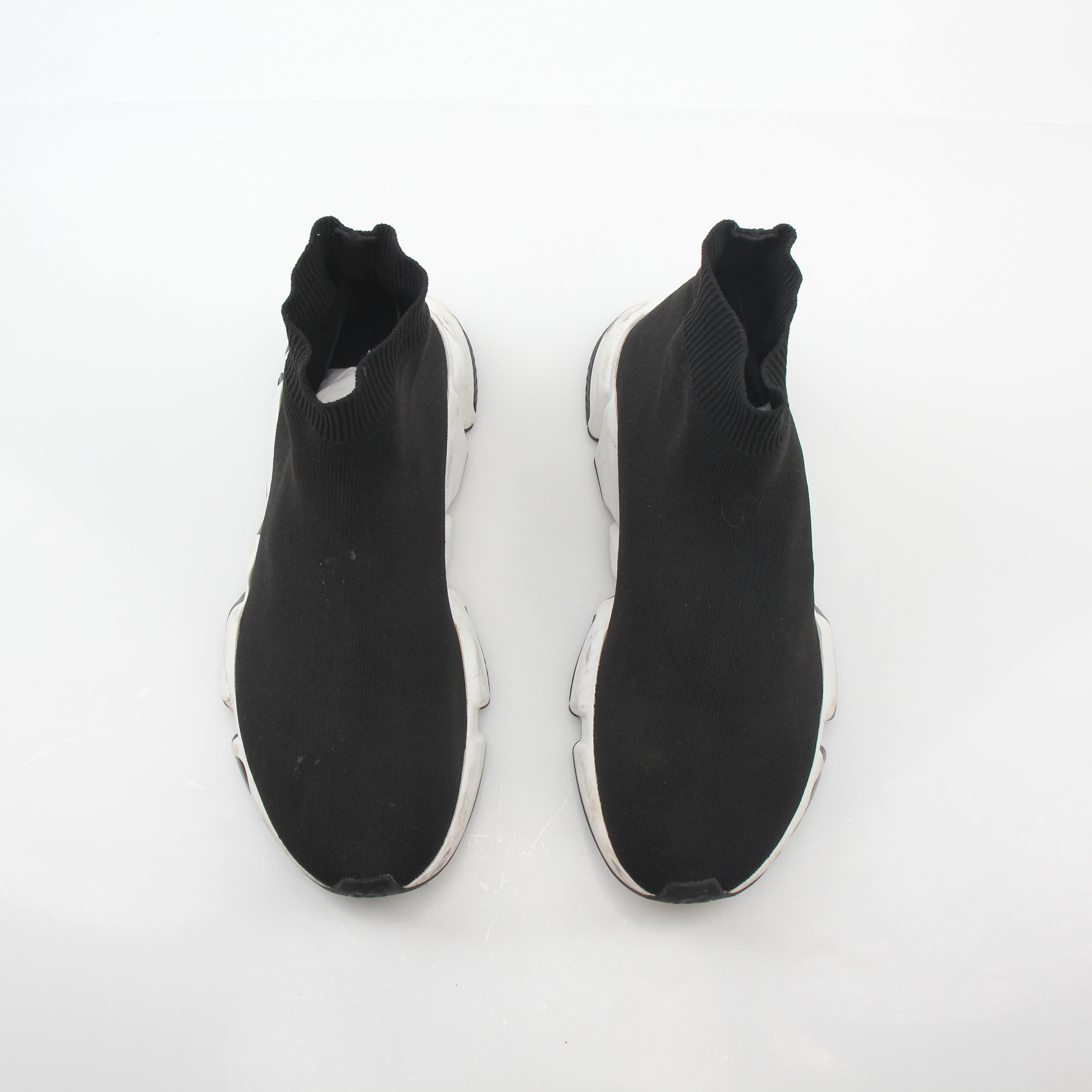 Black Balenciaga Speed Graffiti Sock Sneakers with bold graffiti design and sleek athletic style, worn on a model's feet.