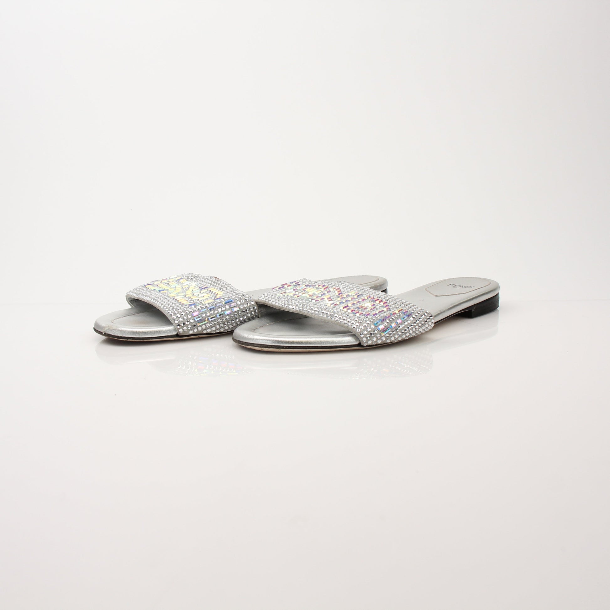 Fendi women's crystal-embellished signature slides, gold-tone shoes with sparkling crystal details, stylish and comfortable footwear.