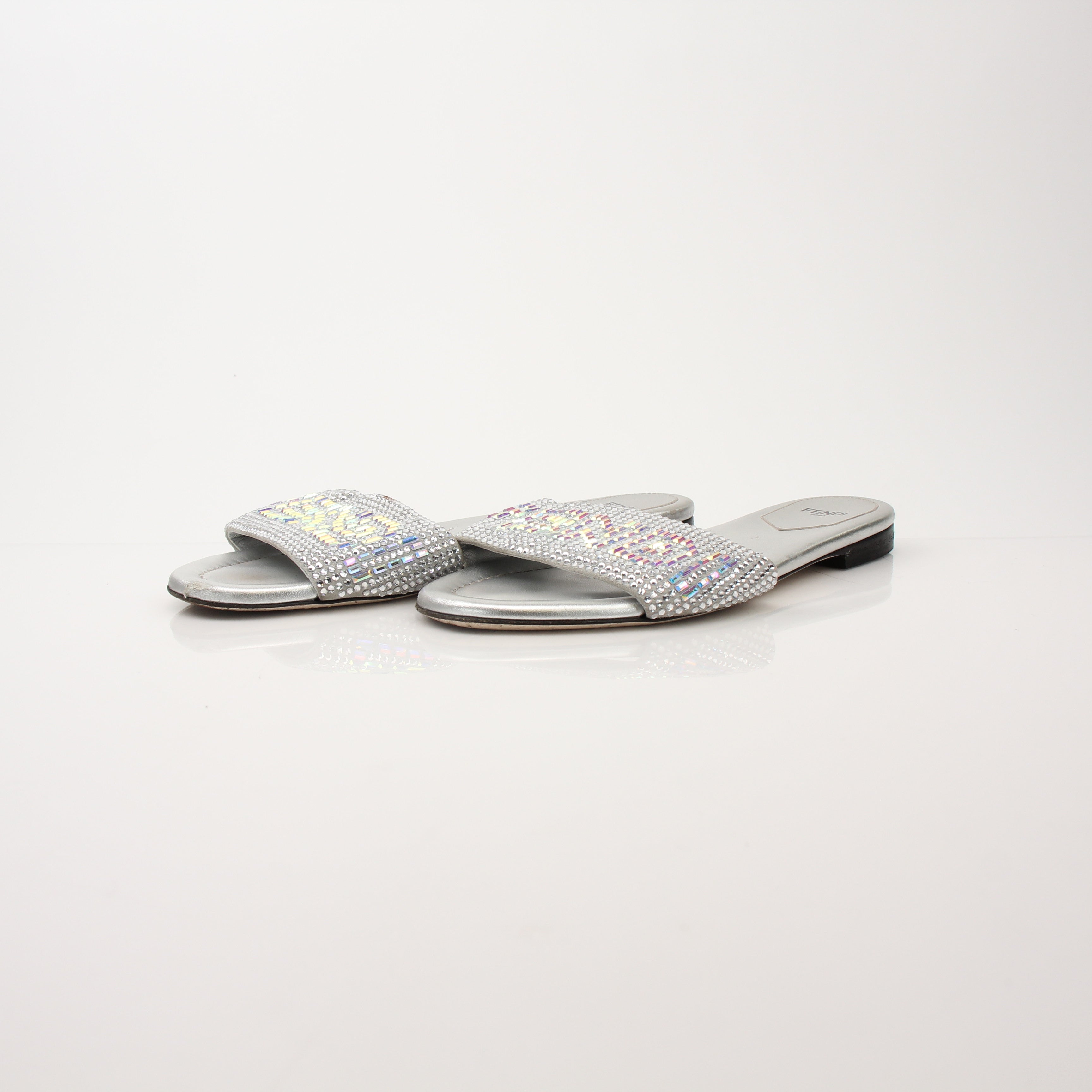 Fendi women's crystal-embellished signature slides, gold-tone shoes with sparkling crystal details, stylish and comfortable footwear.