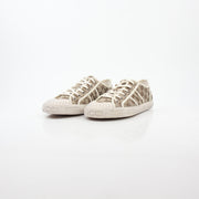 Gold & Beyond Gucci GG Supreme sneakers, stylish shoes with iconic monogram pattern and casual lace-up design, front view.
