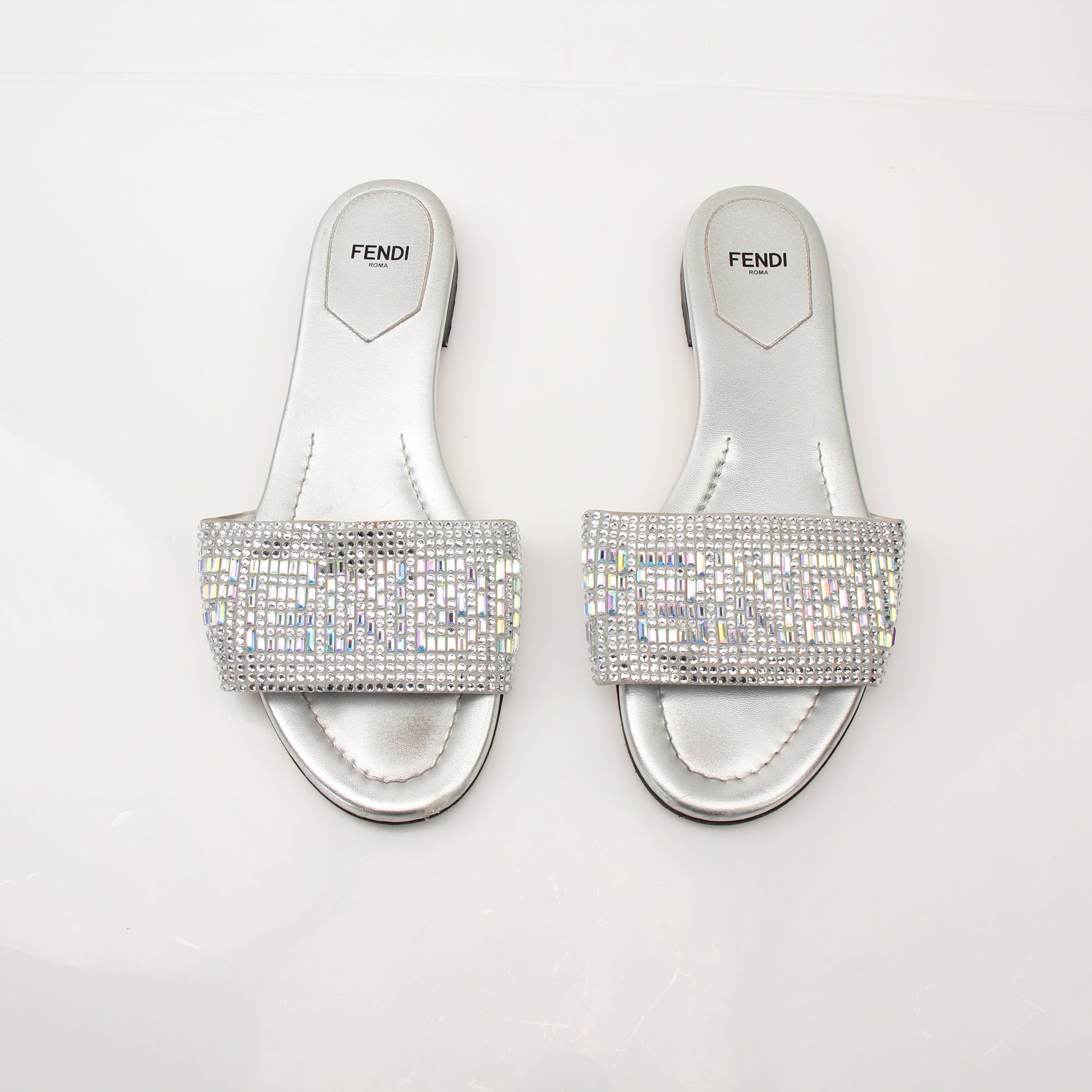 Gold & Beyond Fendi women's crystal-embellished signature slides, stylish open-toe shoes with sparkling crystal details.