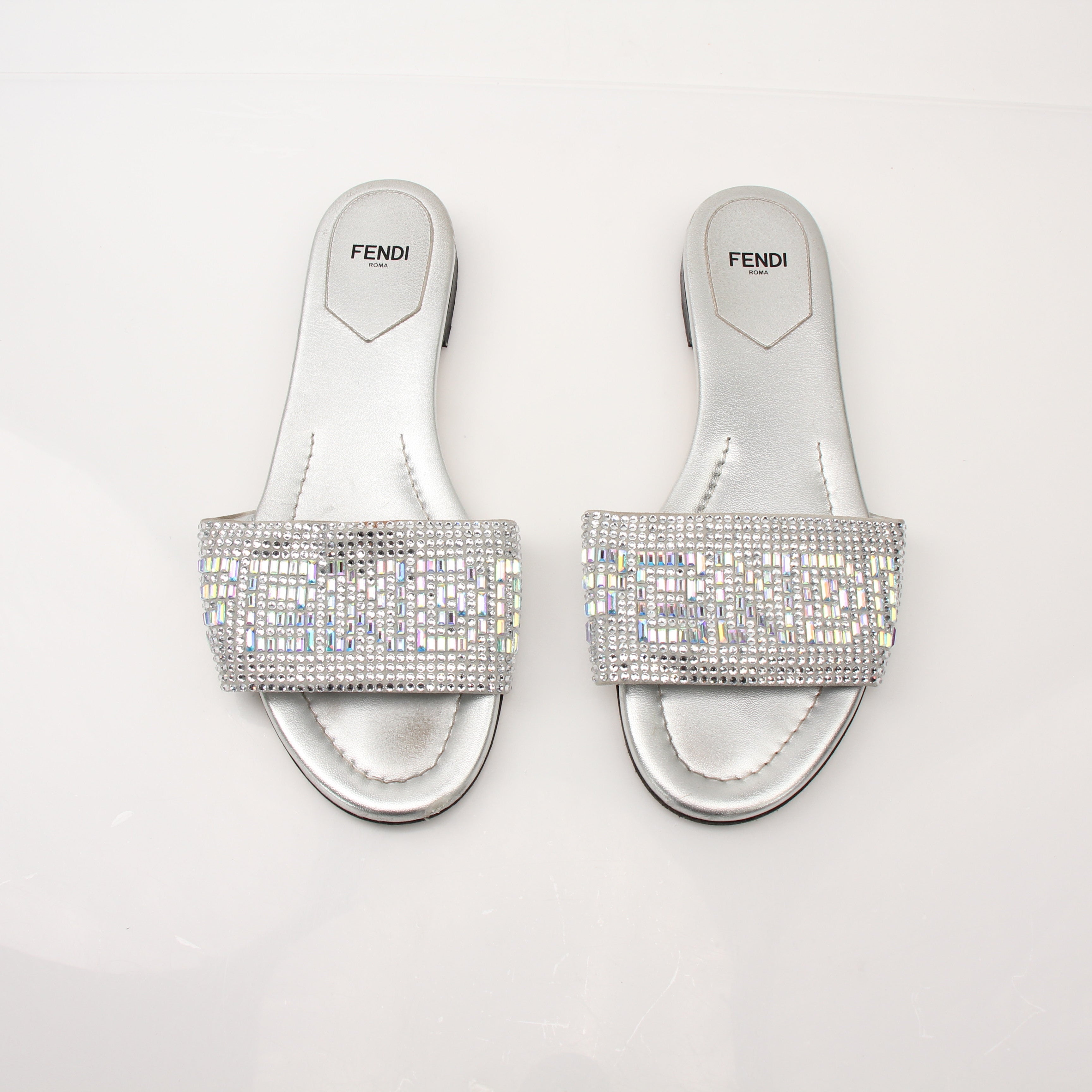 Gold & Beyond Fendi women's crystal-embellished signature slides, stylish open-toe shoes with sparkling crystal details.