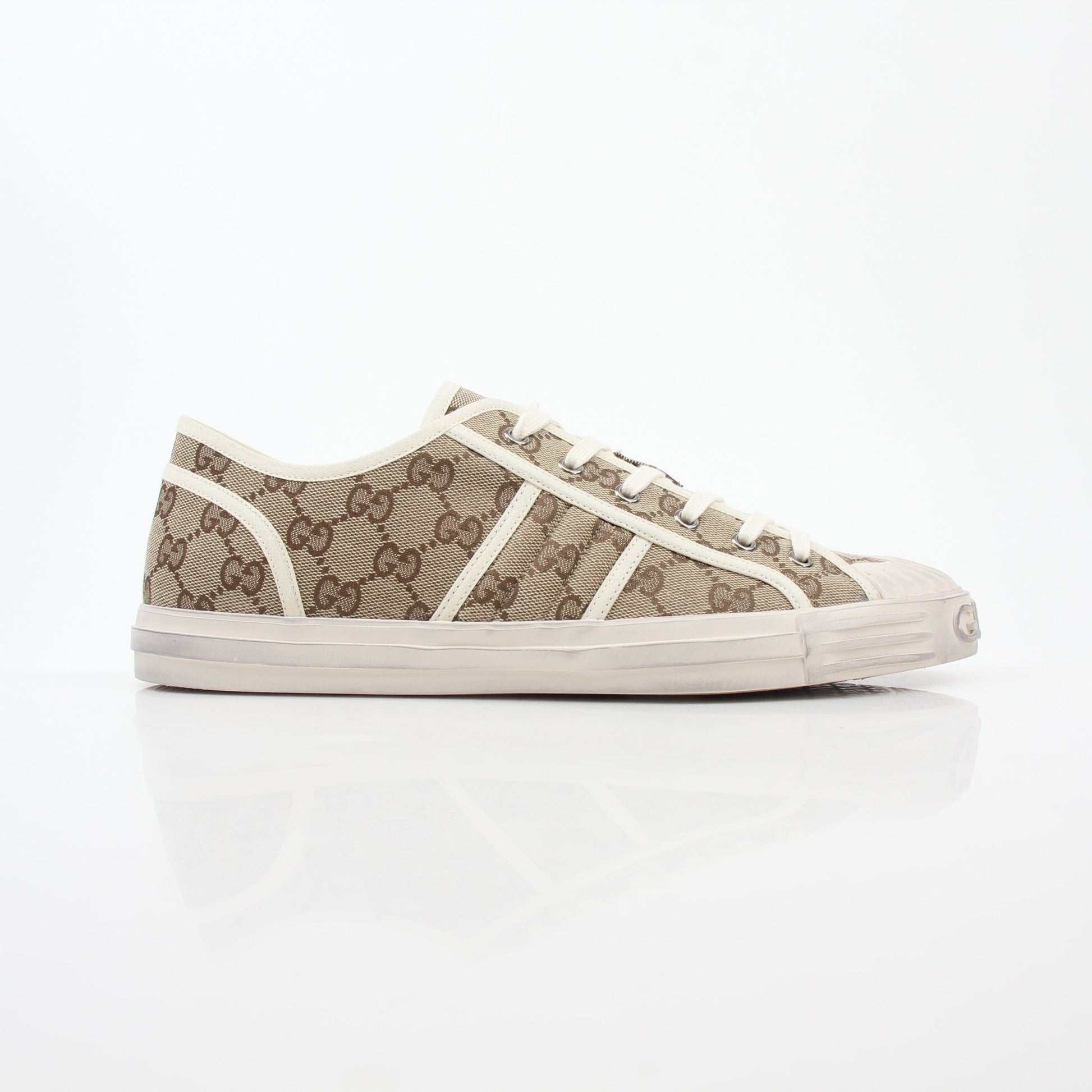 Gold & Beyond Gucci GG Supreme sneakers, stylish shoes with signature monogram pattern, white rubber soles, and lace-up design.