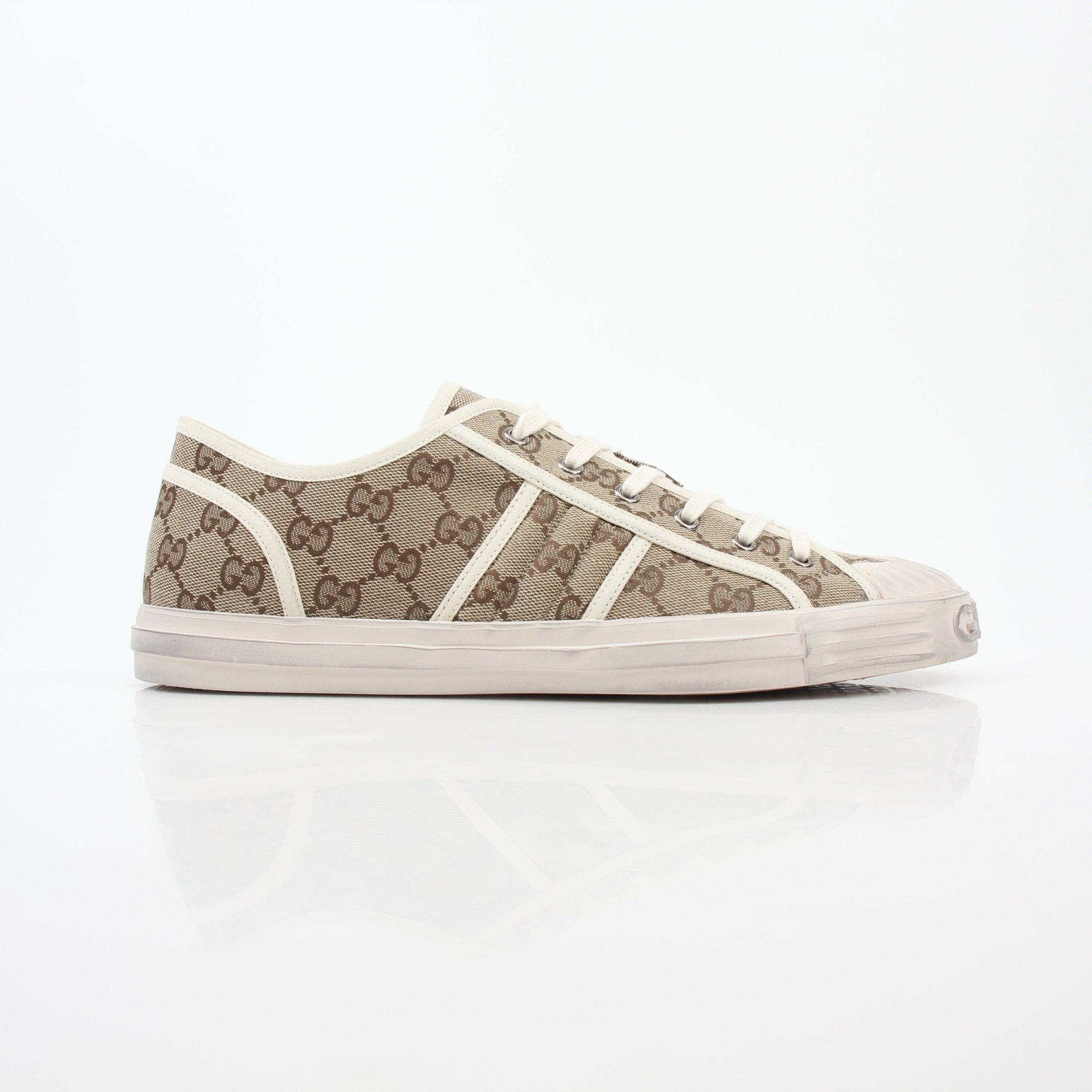 Gold & Beyond Gucci GG Supreme sneakers, stylish shoes with signature monogram pattern, white rubber soles, and lace-up design.