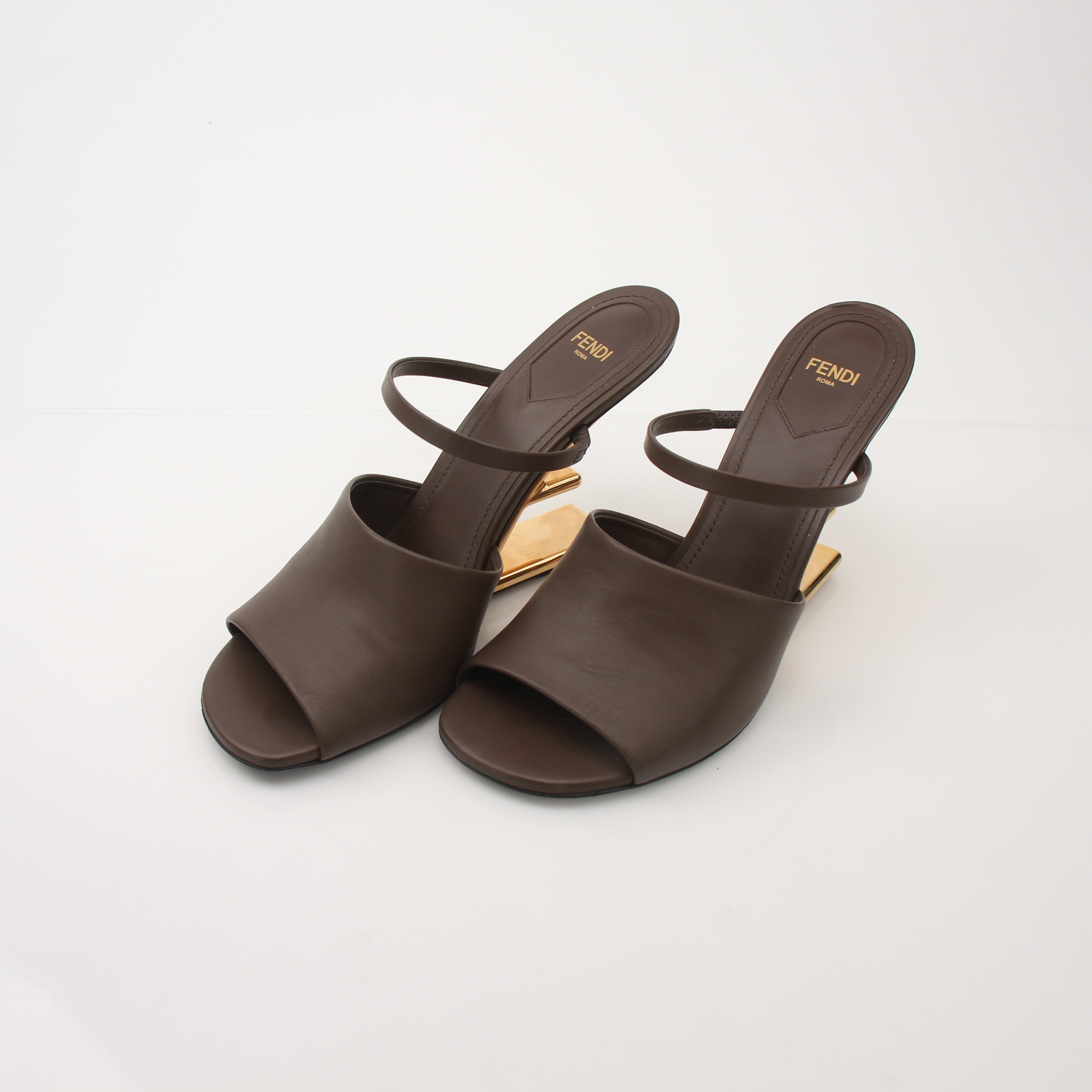 Gold & Beyond Fendi First Sculpted Heel Sandals, elegant nude heels with sculpted design and ankle straps, on a white background.