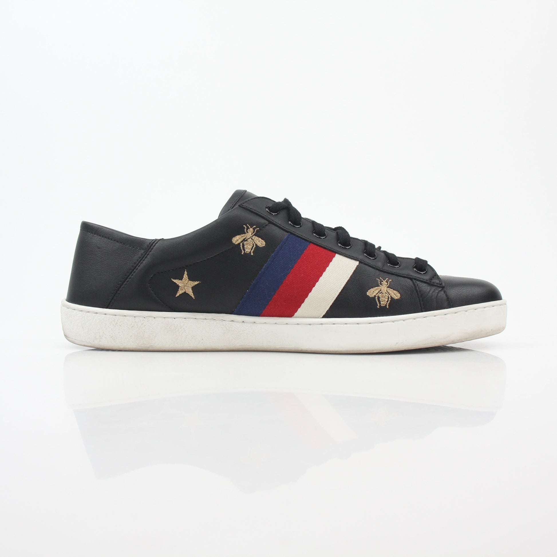 Gucci black embroidered Ace Web low-top sneakers featuring iconic logo embroidery and sleek leather design.