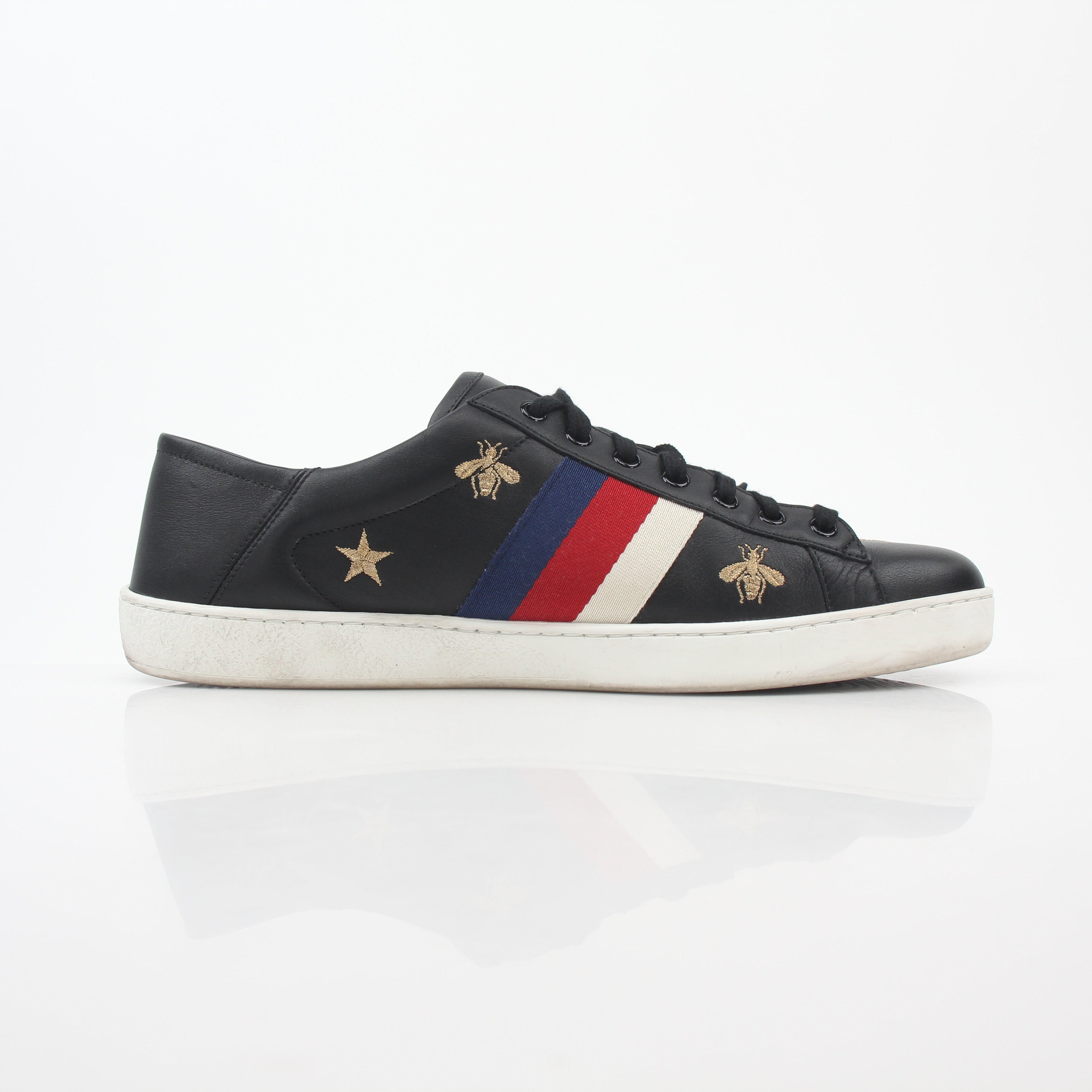 Gucci black embroidered Ace Web low-top sneakers featuring iconic logo embroidery and sleek leather design.