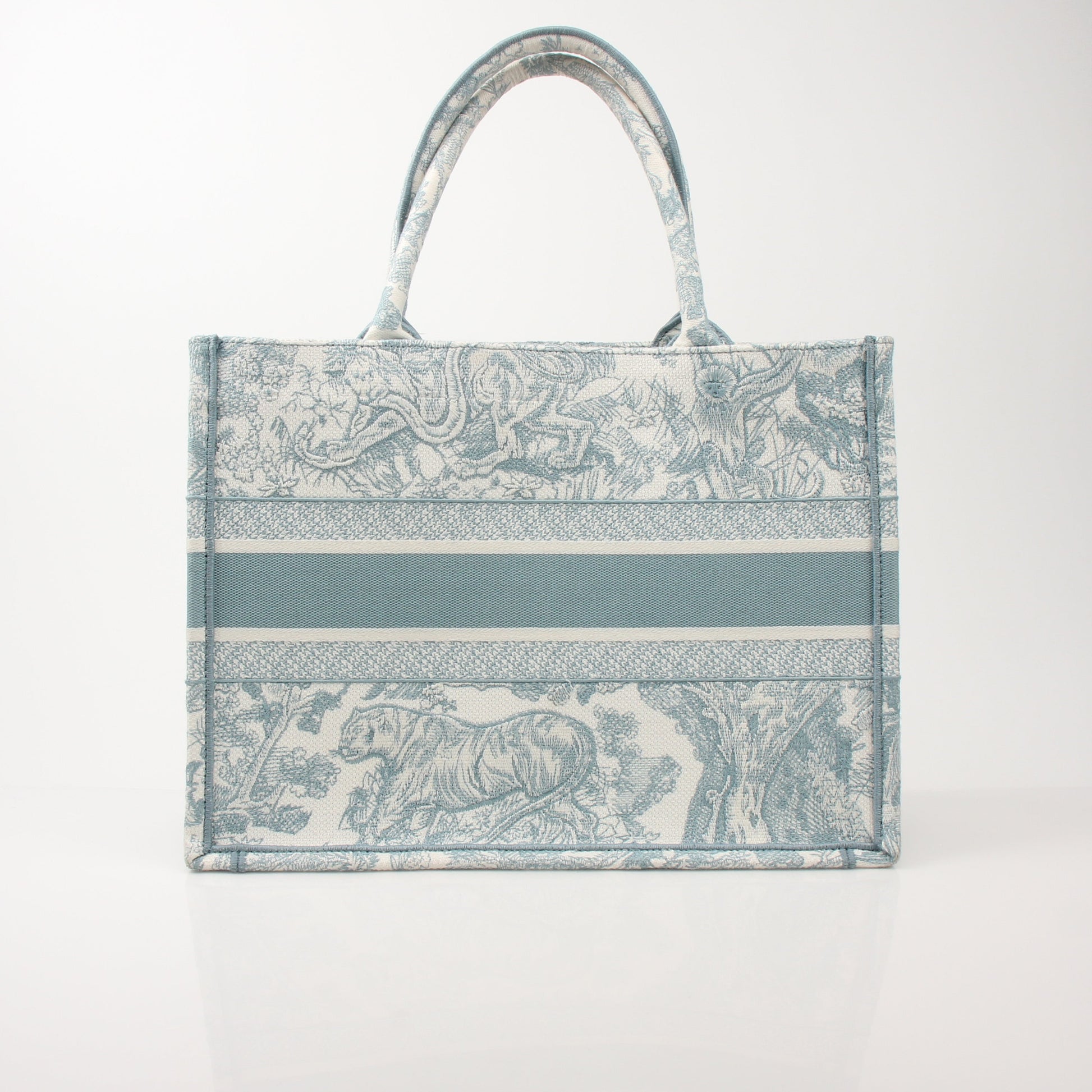 Christian Dior Toile de Jouy Book Tote handbag with white and blue patterned fabric and leather handles.