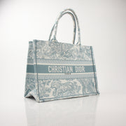 Christian Dior Toile de Jouy Book Tote handbag with floral pattern and structured design, featuring gold-tone handles and leather accents.