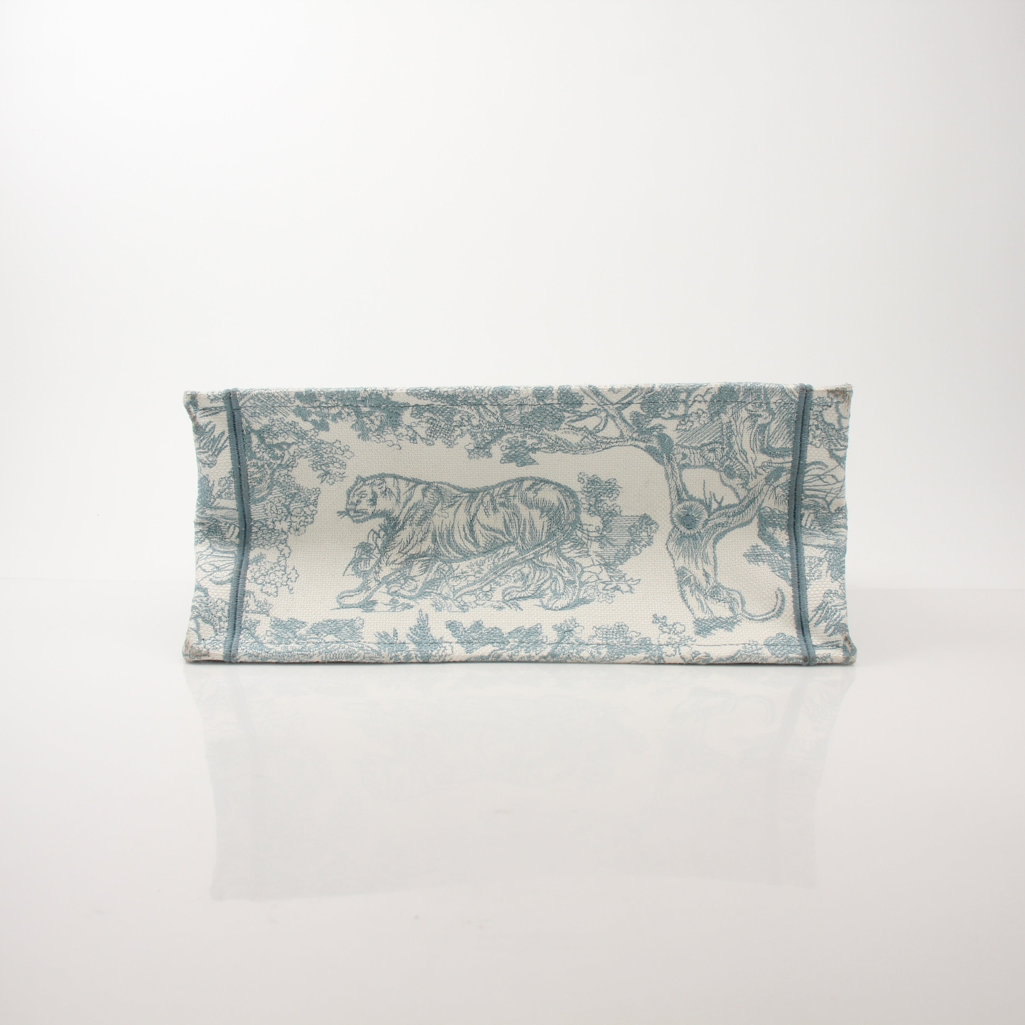 Christian Dior Toile de Jouy Book Tote handbag with white and blue floral pattern, featuring sturdy handles and a spacious interior.